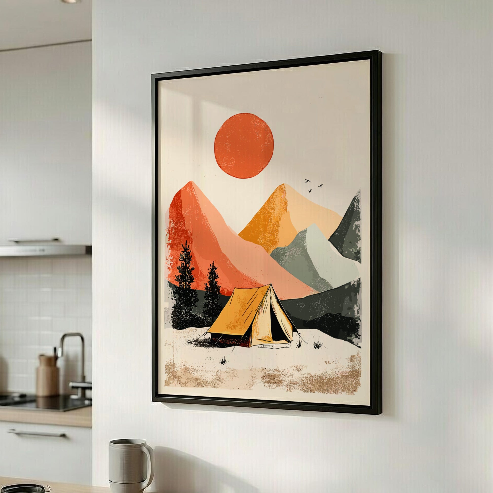 Framed artwork of a tent in a mountainous landscape on a kitchen wall