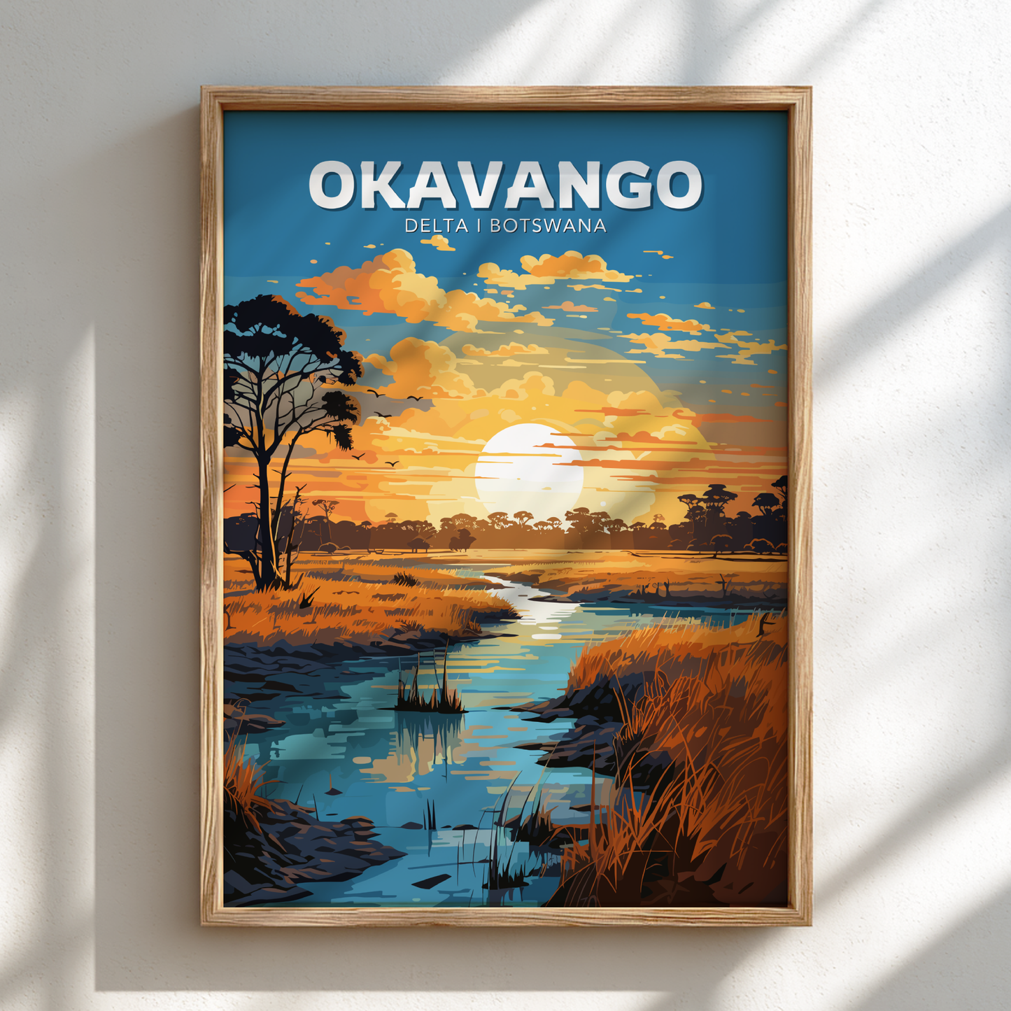 Framed artwork of the Okavango Delta in Botswana with a sunset over water and trees.
