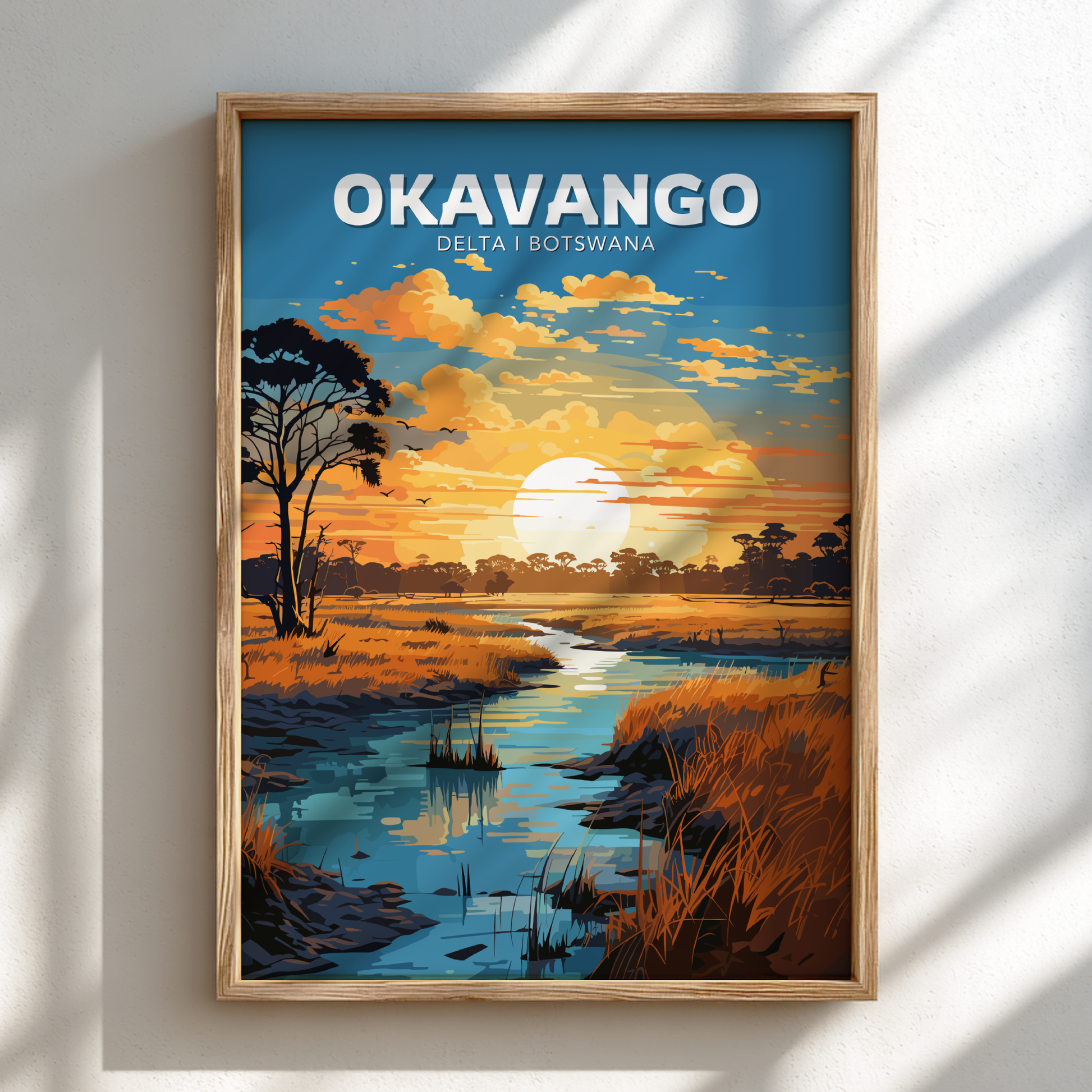 Framed artwork of the Okavango Delta in Botswana with a sunset over water and trees.