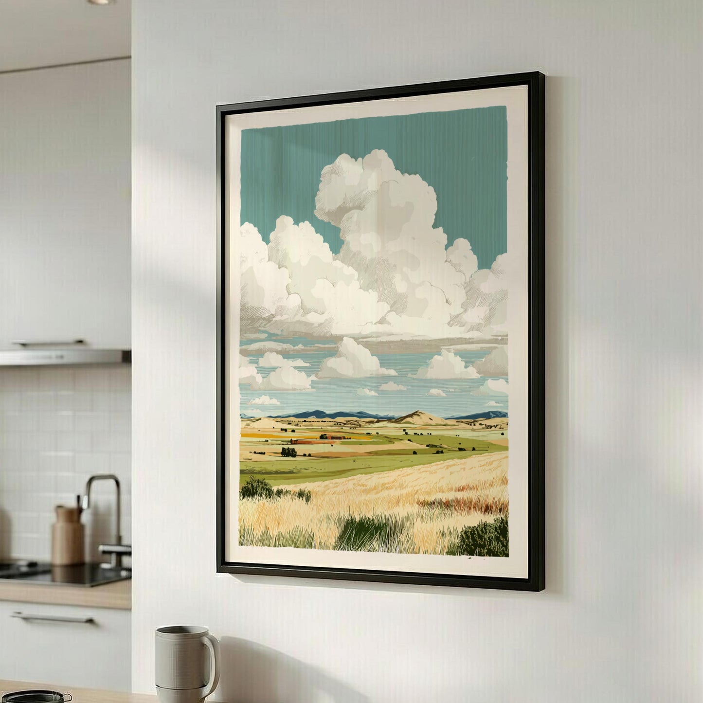 Framed landscape print of a field and clouds on a wall in a kitchen.