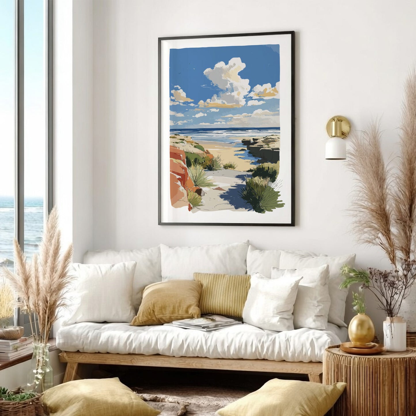 Living room with a white sofa, decorative pillows, and a framed beach scene print on the wall.