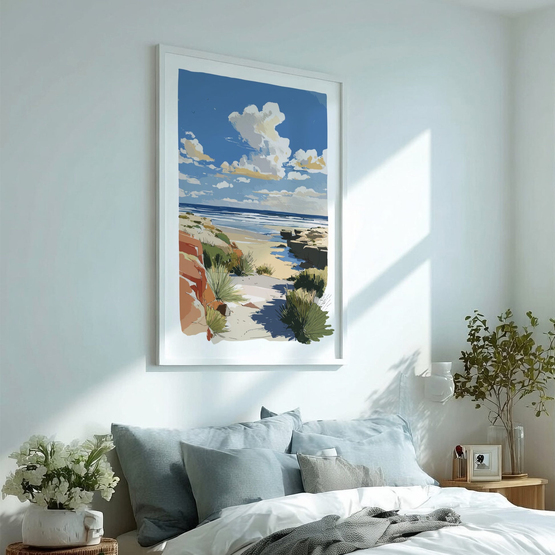Framed beach artwork above a bed in a bright bedroom