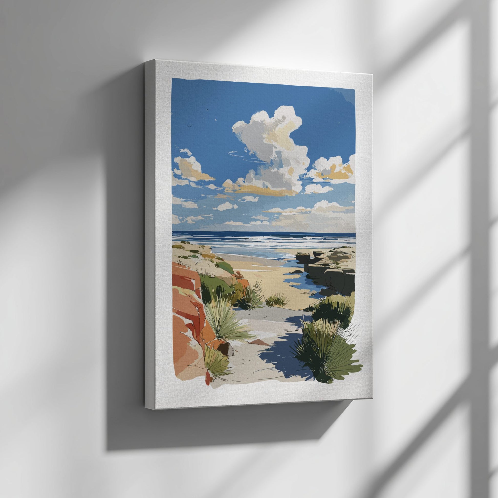 Framed artwork of a beach scene with a blue sky and clouds on a gray wall.