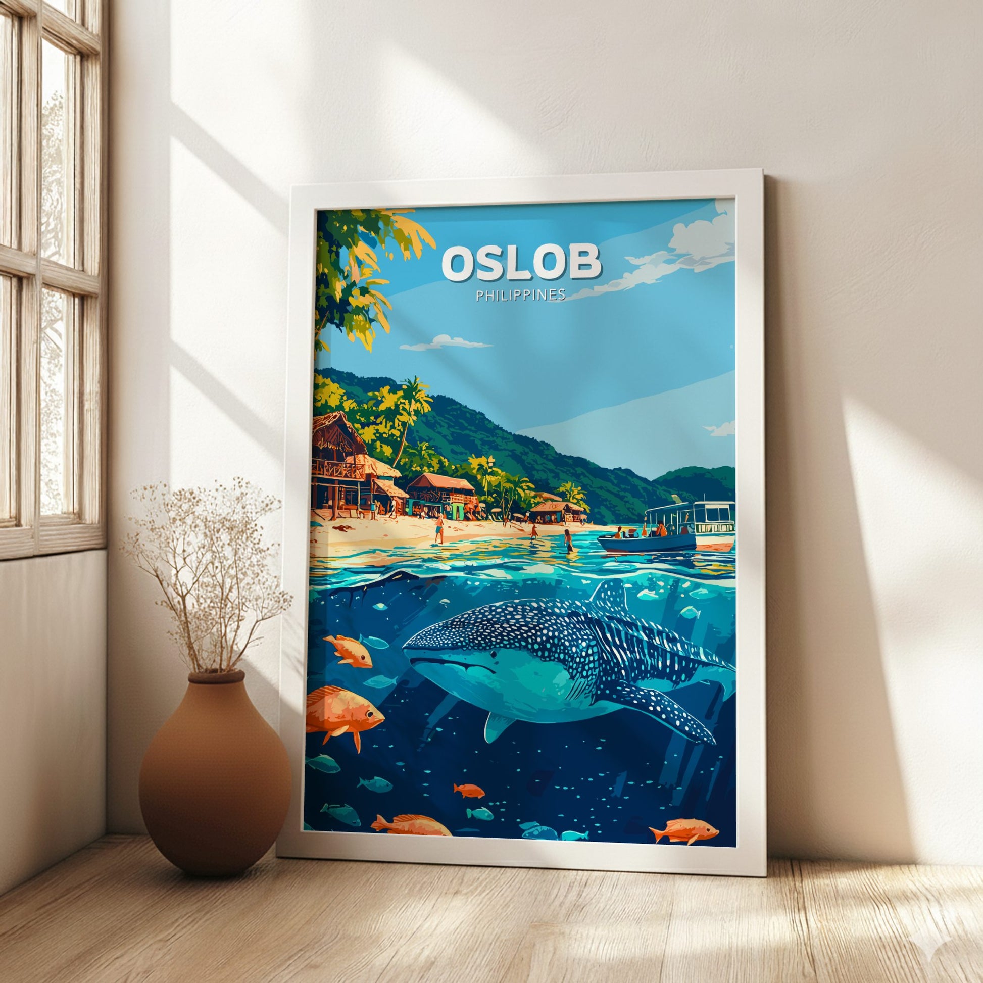 Framed poster of Oslob, Philippines with a beach and whale shark scene, placed on a wall.