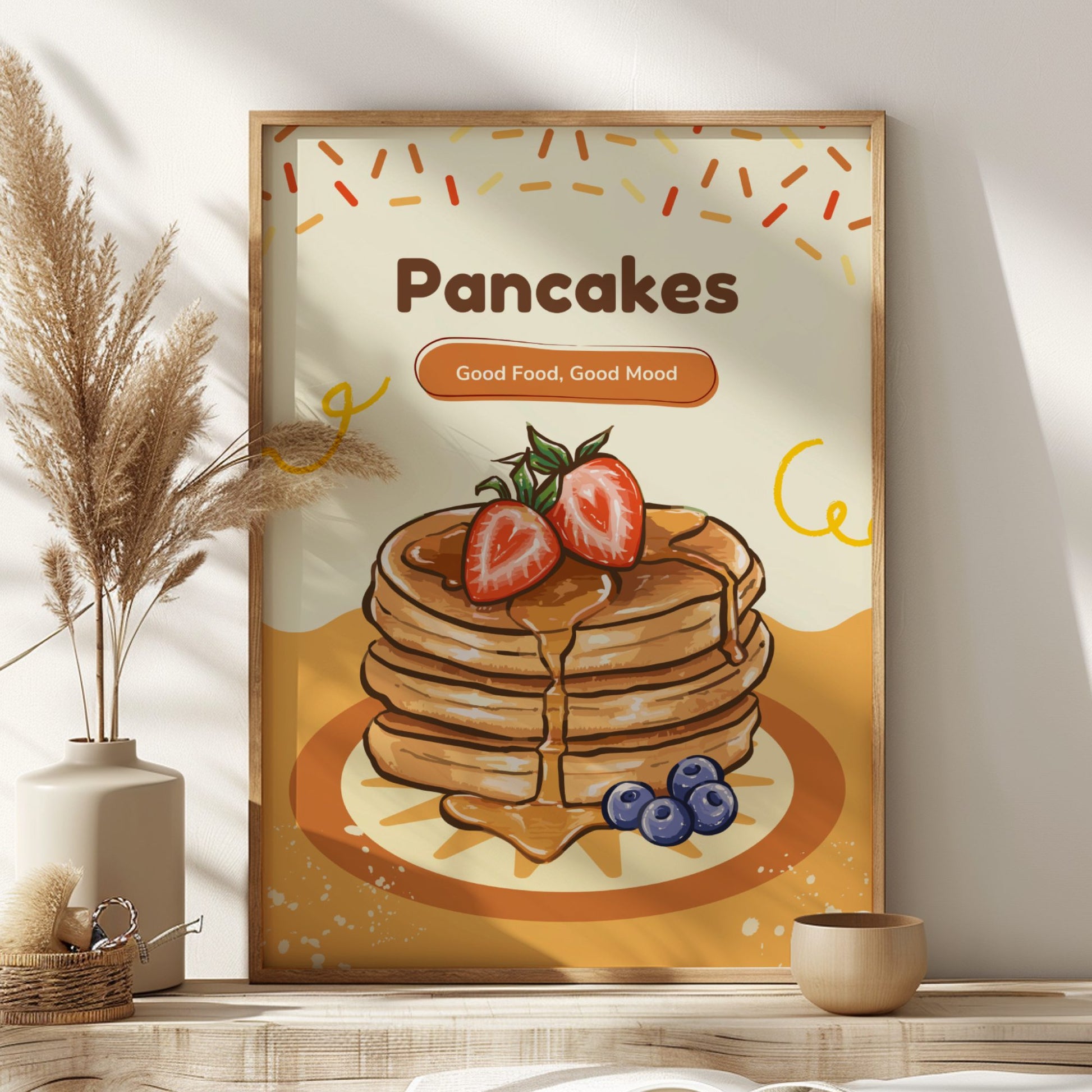 Framed artwork of pancakes with strawberries and blueberries on a wall above a shelf.
