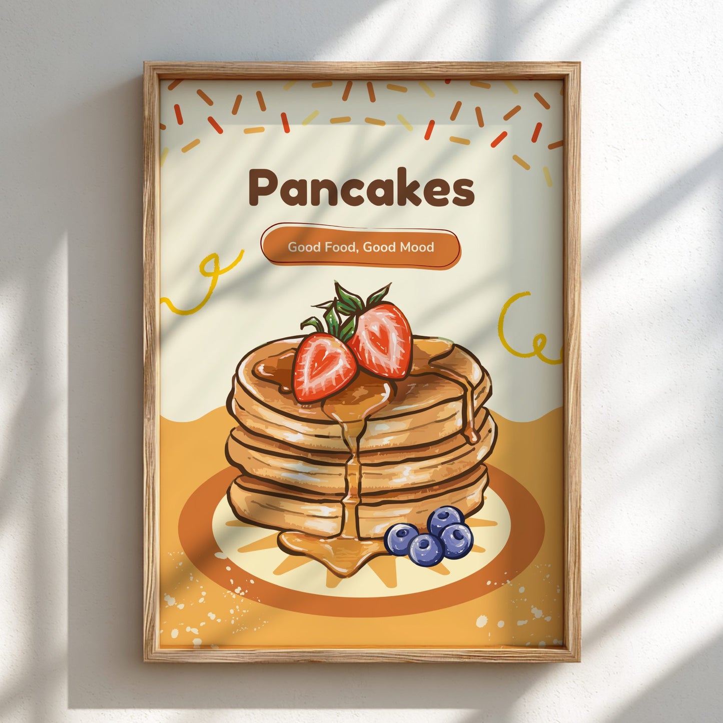 Framed artwork of pancakes with berries and syrup on a light background