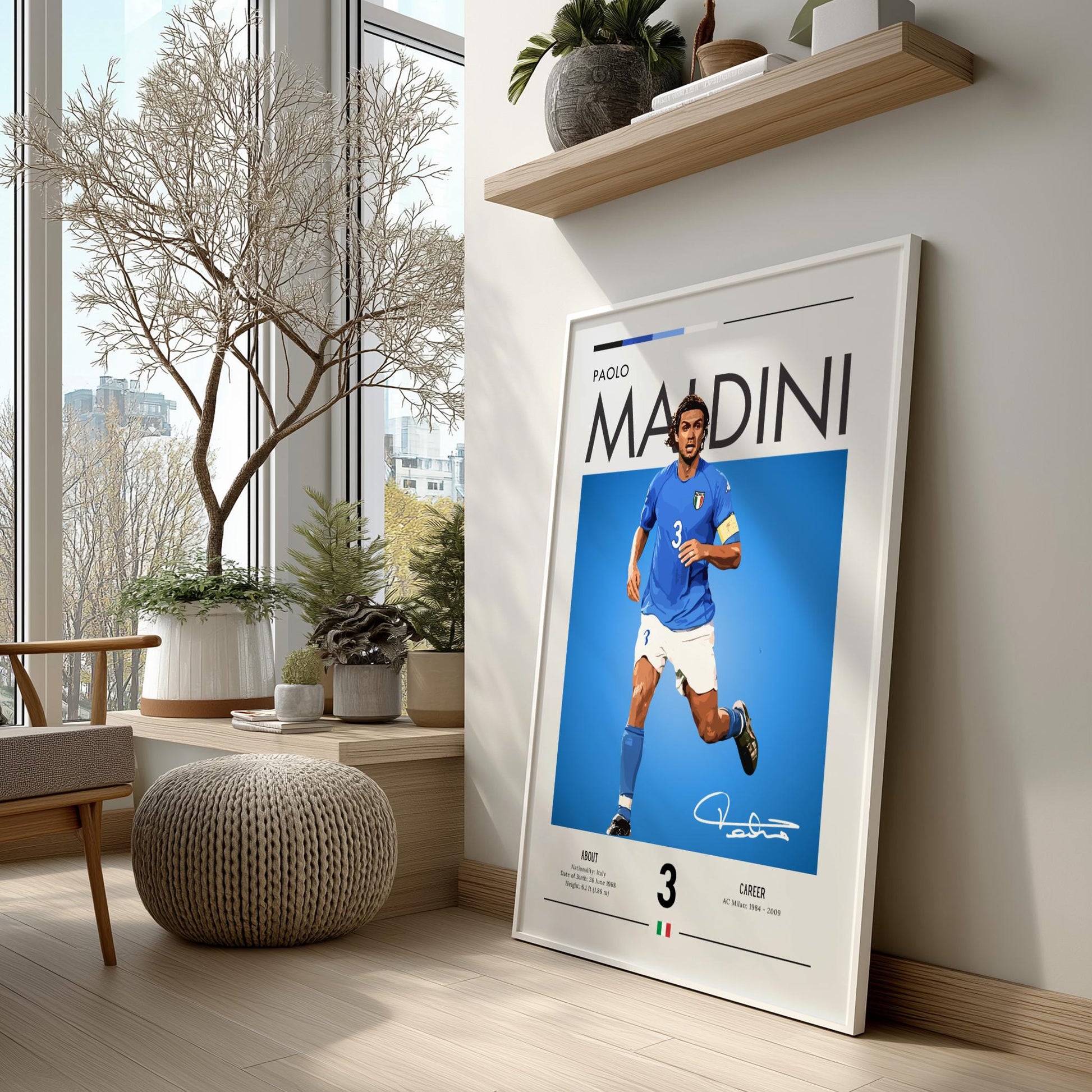 Framed poster of a soccer player in a modern living room with large windows.