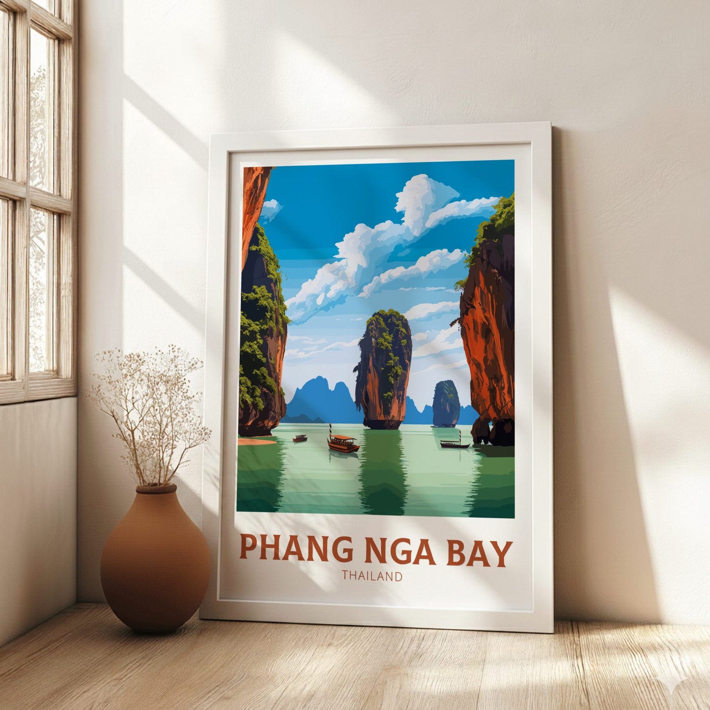 Framed poster of Phang Nga Bay with a vase on a wooden floor.