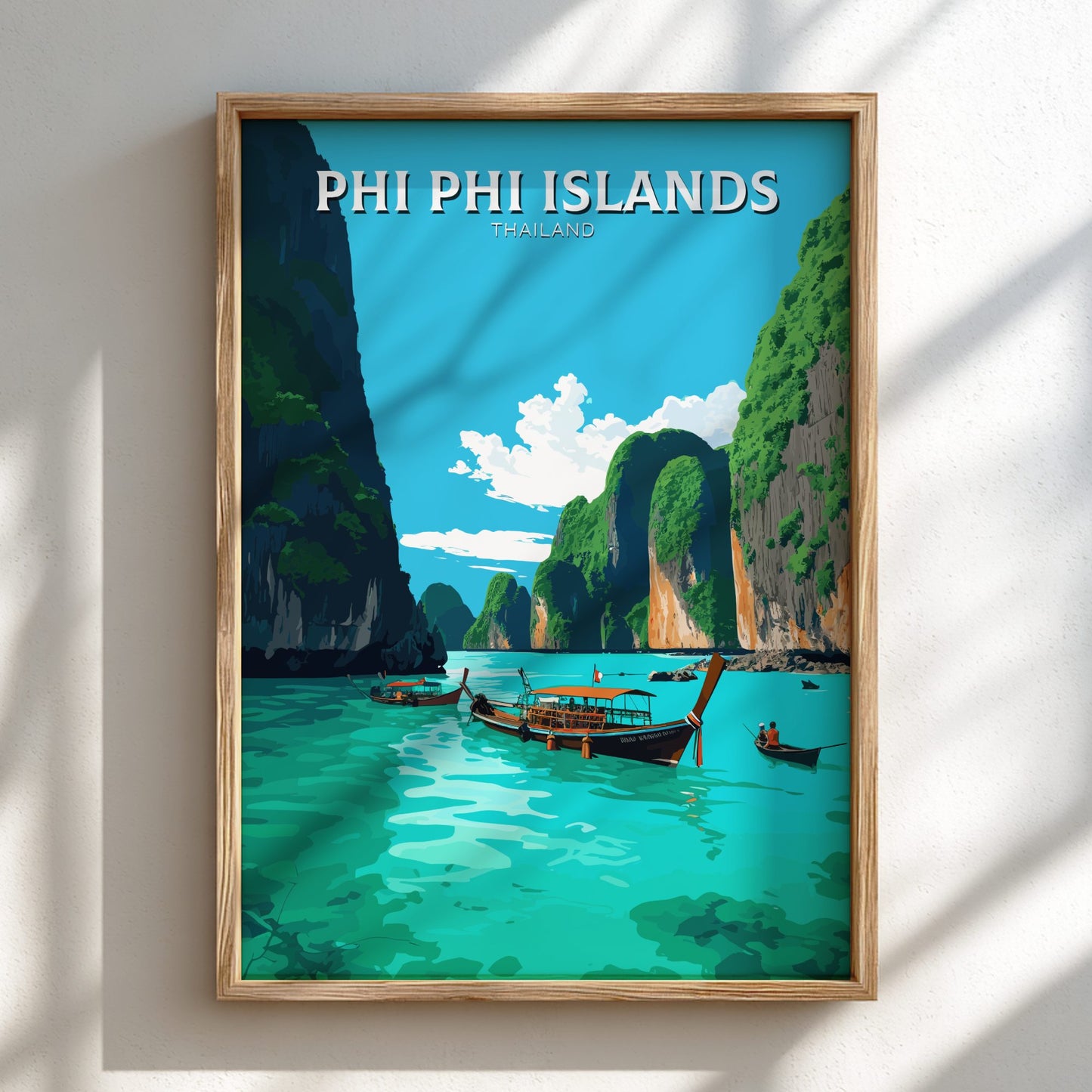 Framed artwork of Phi Phi Islands with boats and cliffs on a blue sky background.