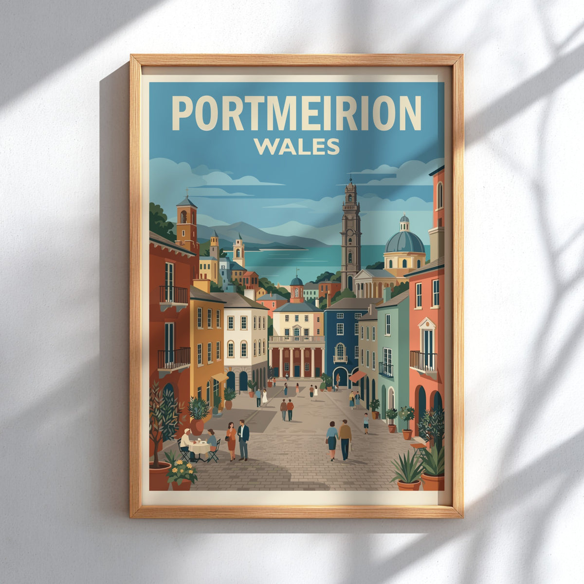Poster of Portmeirion Wales featuring colourful Italianate architecture, a clock tower, and people walking.