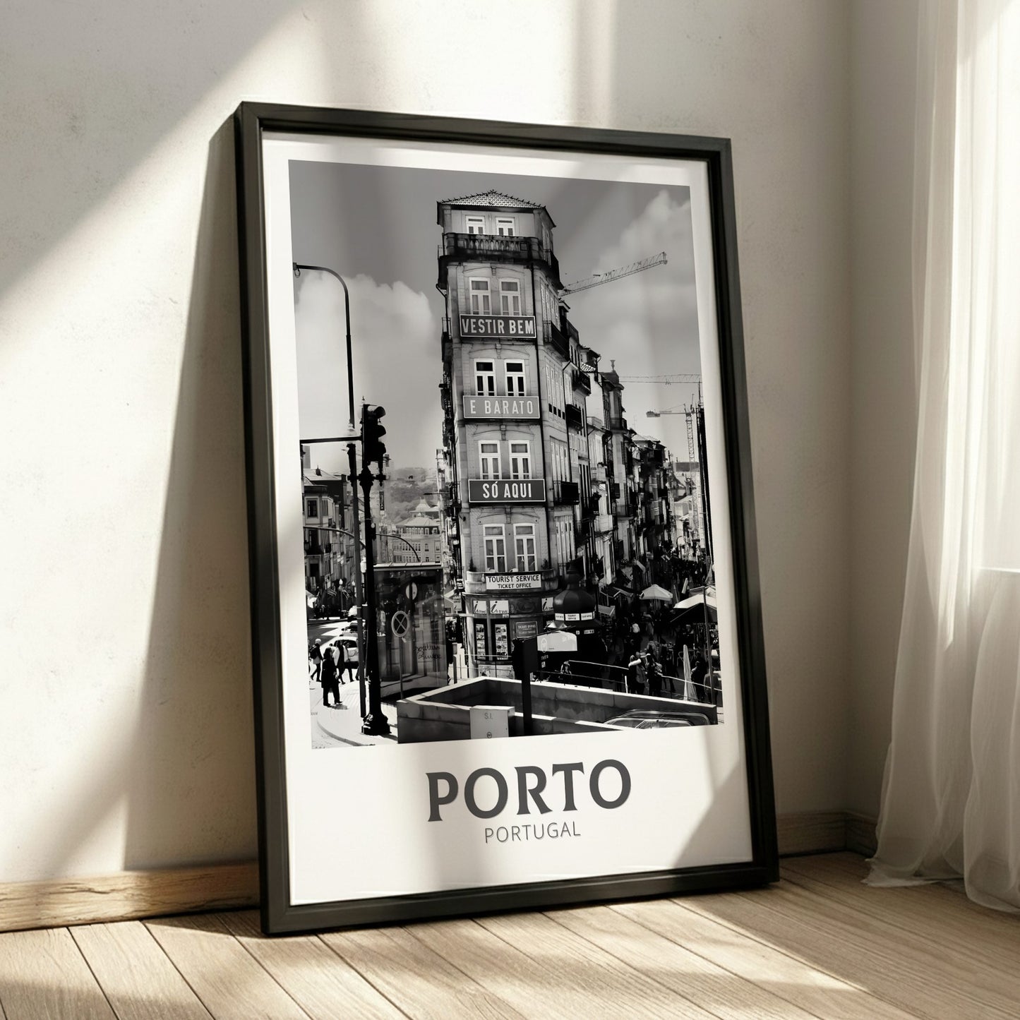 Framed black and white poster of Porto, Portugal on a wall.