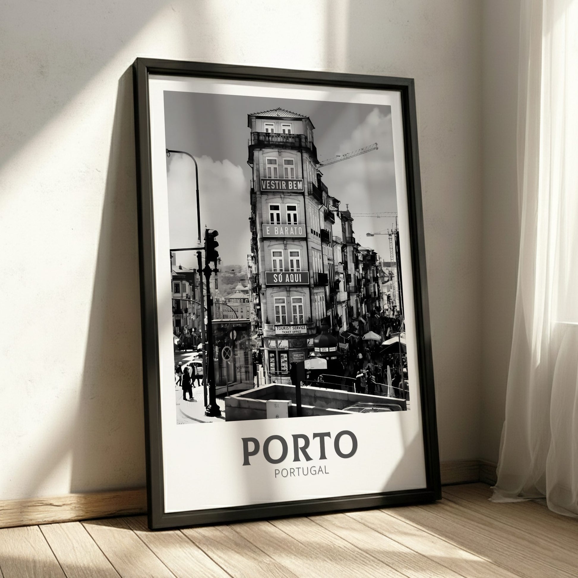 Framed black and white poster of Porto, Portugal on a wall.