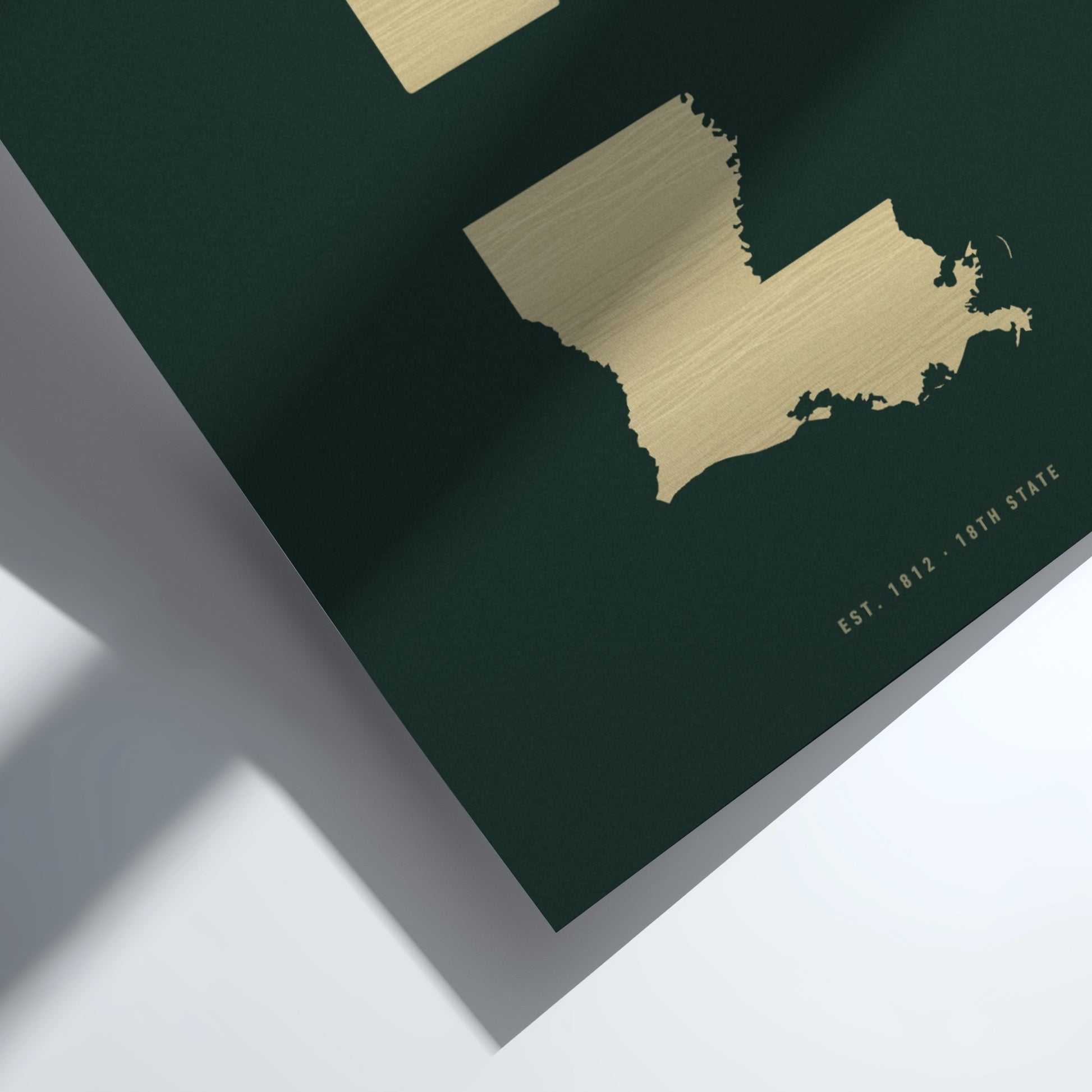 Gold map of Maine on a dark green background