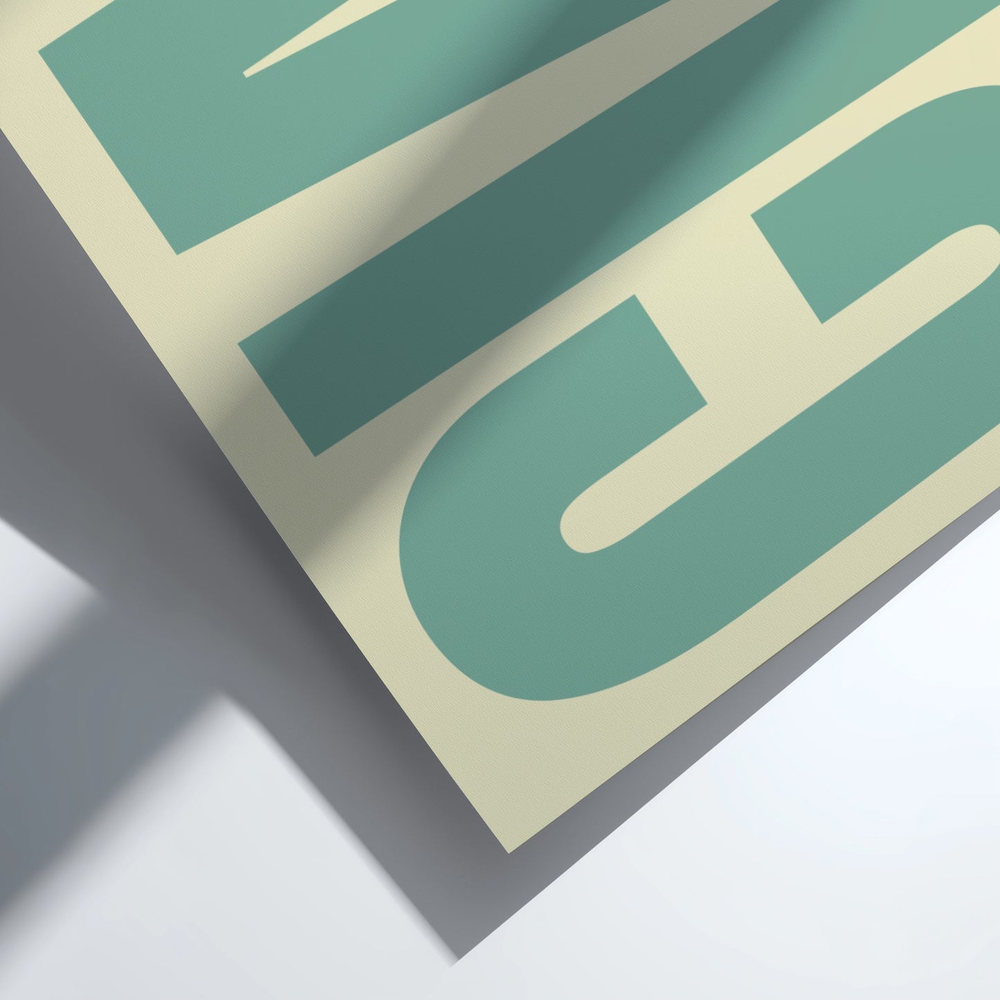 Close-up of a green and beige logo on a gray surface