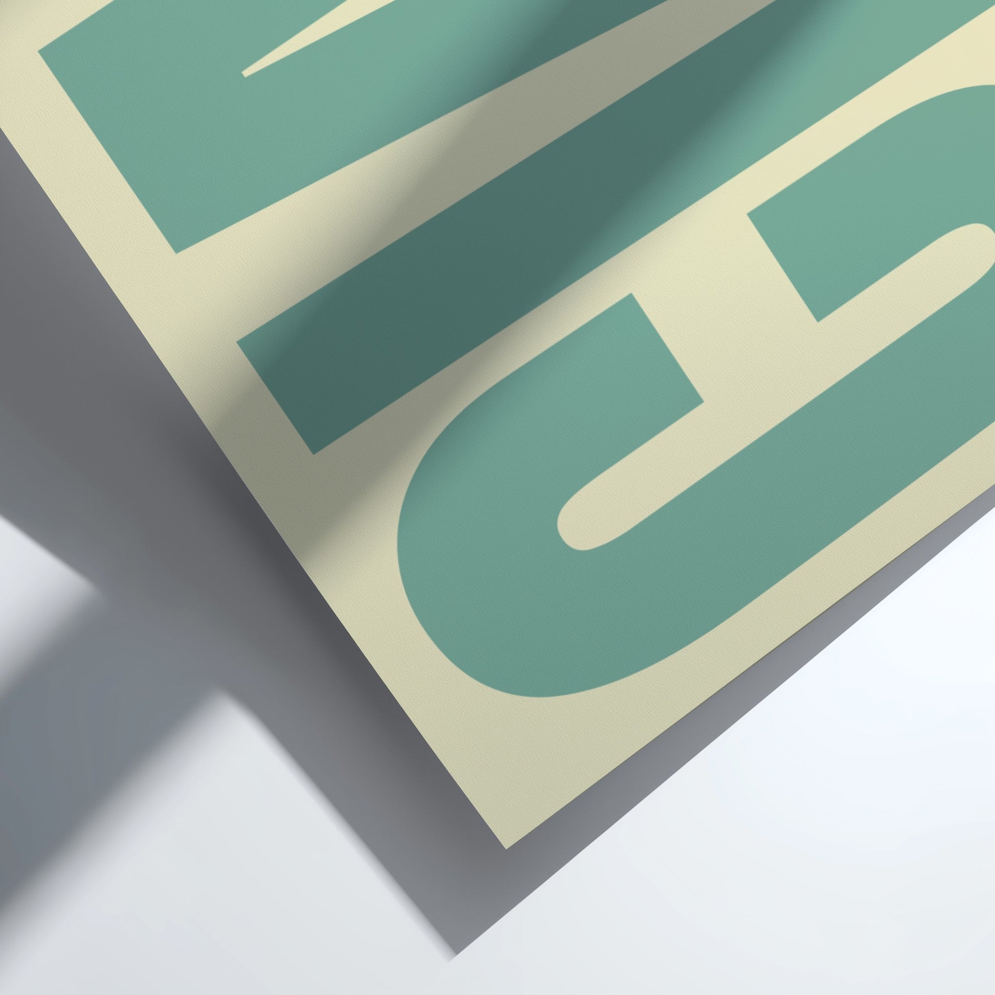 Close-up of a green and beige logo on a gray surface