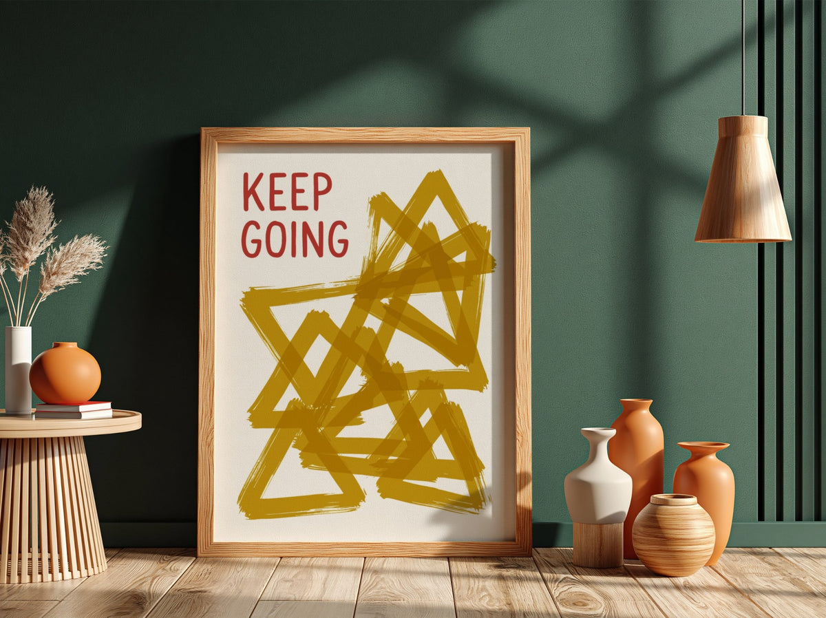 Motivational poster featuring the text Keep Going alongside abstract overlapping mustard yellow triangles.