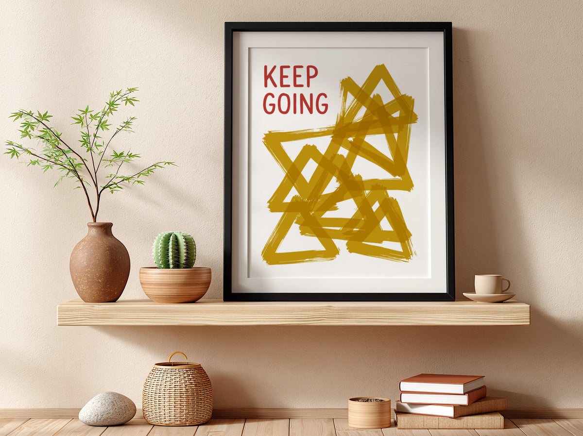 Motivational poster featuring the text Keep Going alongside abstract overlapping mustard yellow triangles.