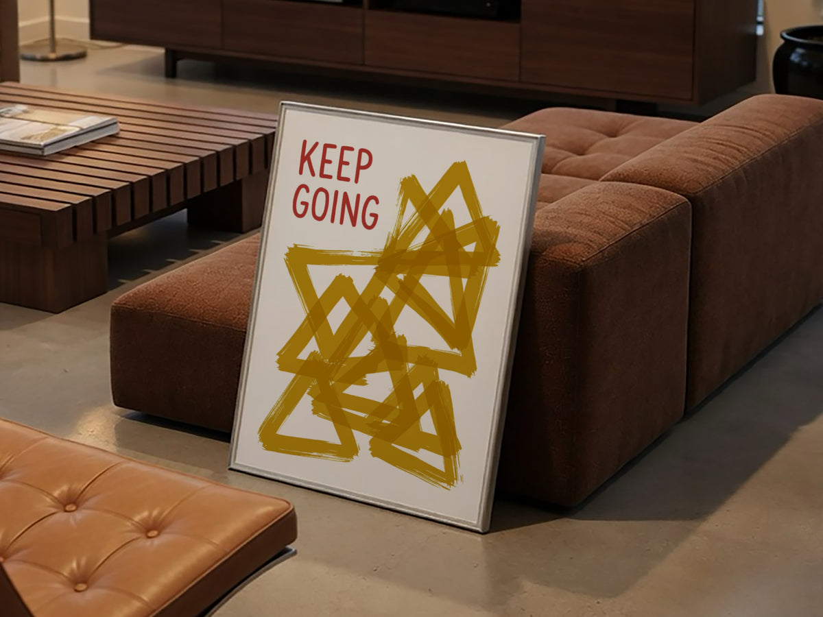 Motivational poster featuring the text Keep Going alongside abstract overlapping mustard yellow triangles.