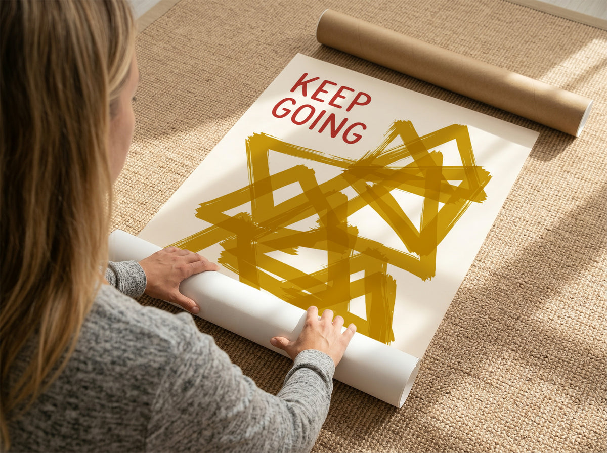 Motivational poster featuring the text Keep Going alongside abstract overlapping mustard yellow triangles.