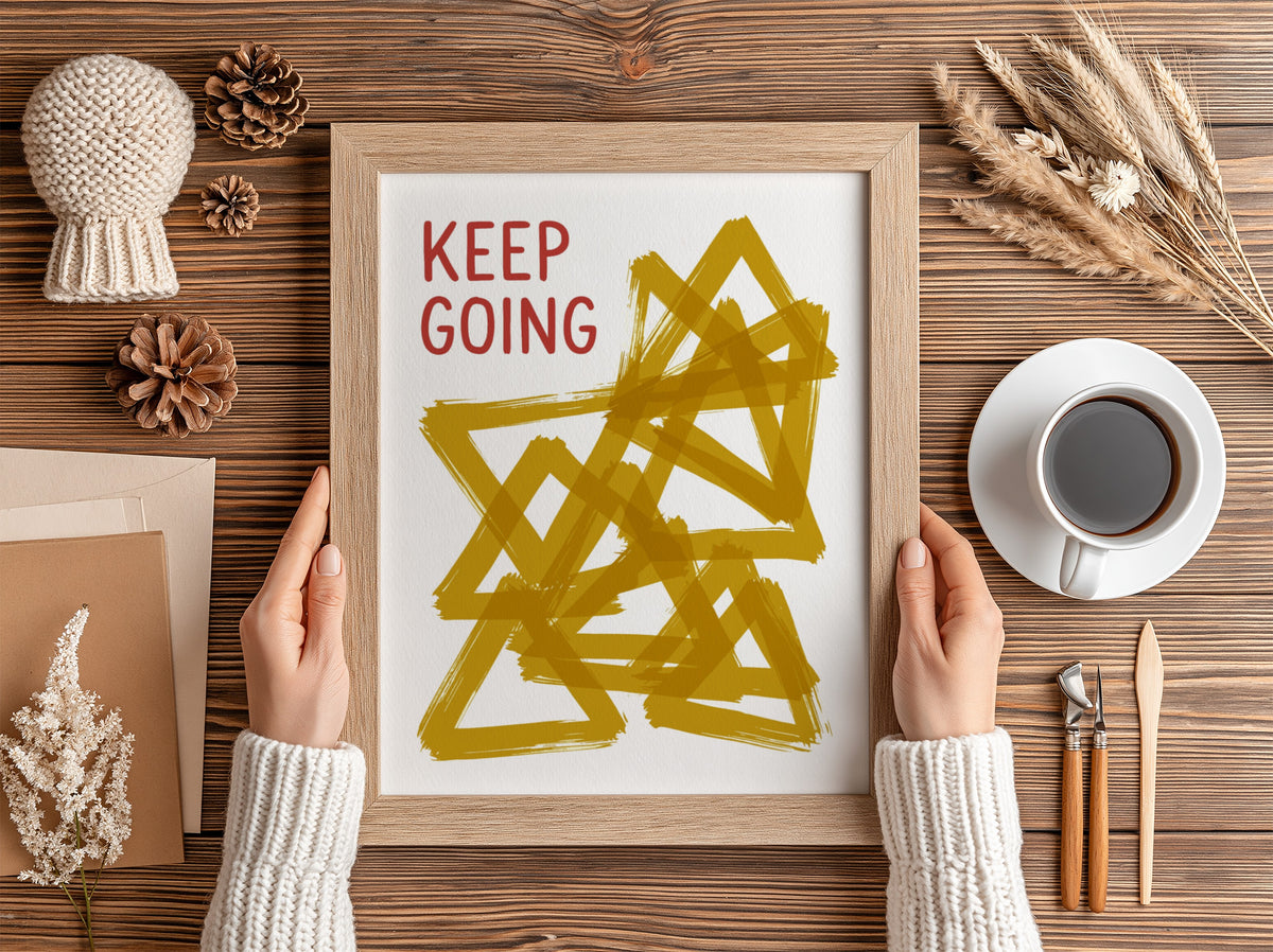 Motivational poster featuring the text Keep Going alongside abstract overlapping mustard yellow triangles.