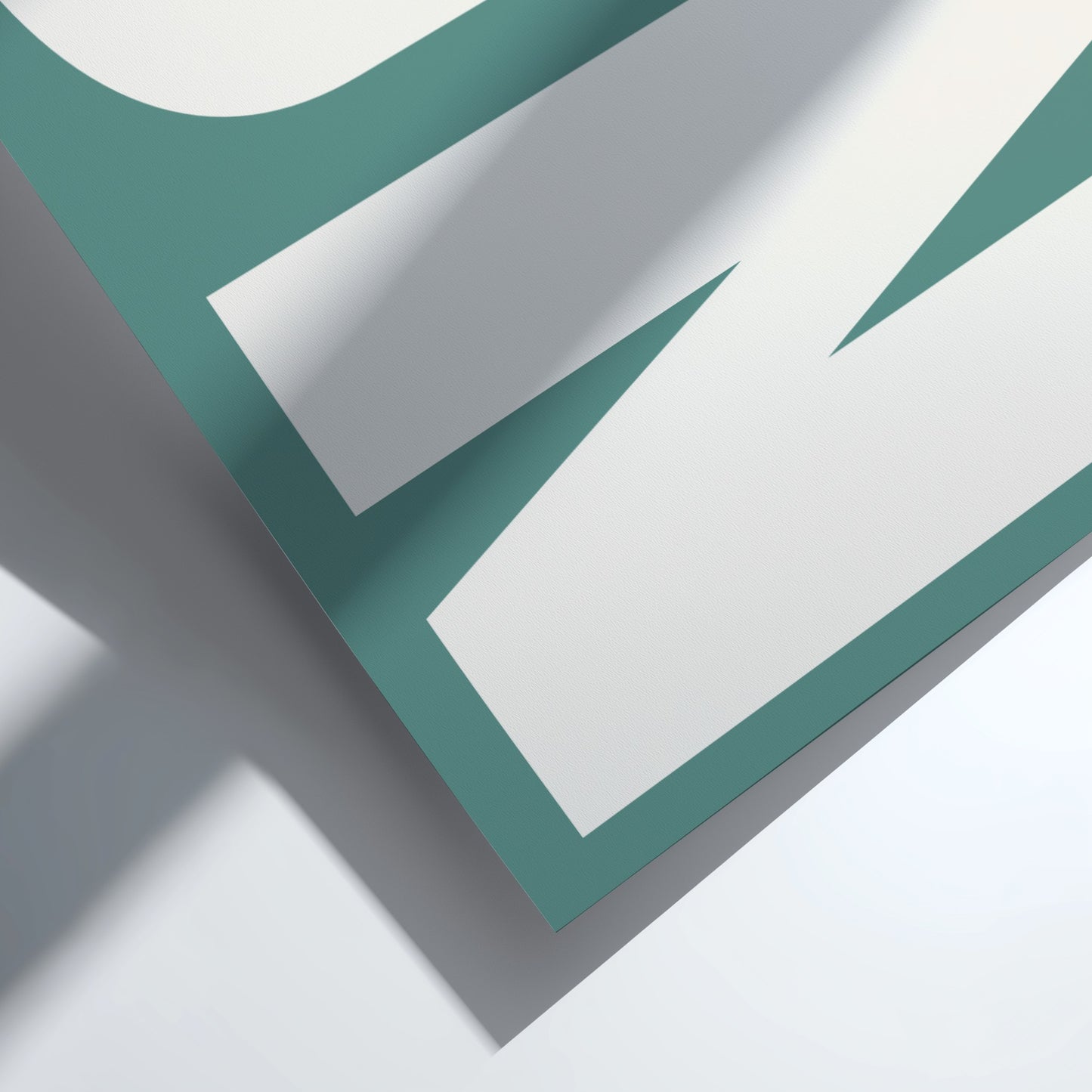 Close-up of a teal and white geometric design on a light gray background