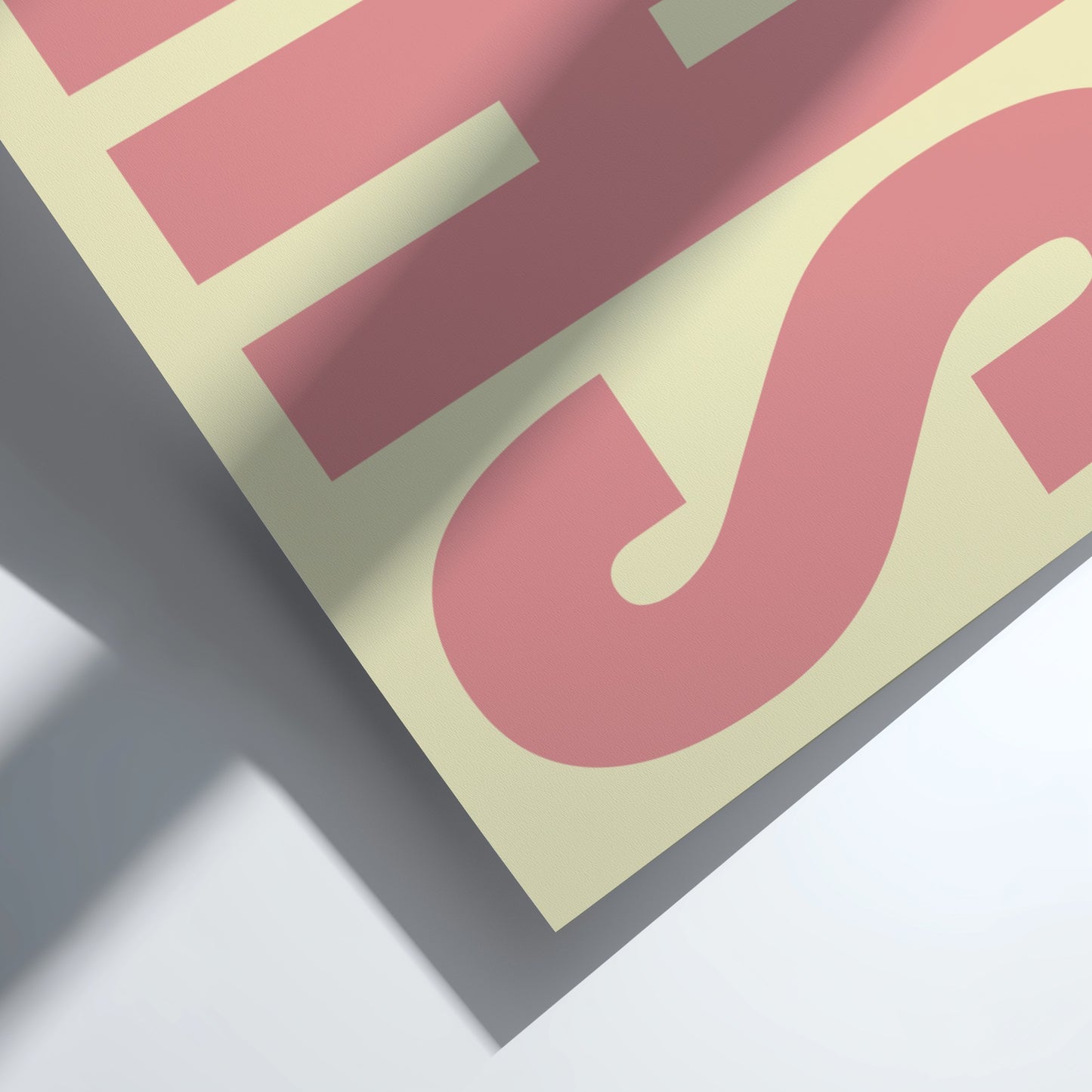 Close-up of a pink and beige poster featuring bold typography, modern wall art for home decor
