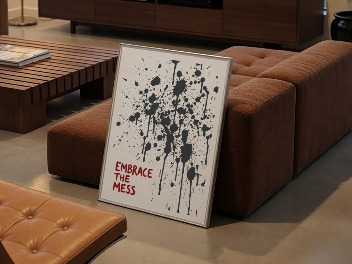 Motivational poster featuring Embrace The Mess text with abstract black ink splatter design