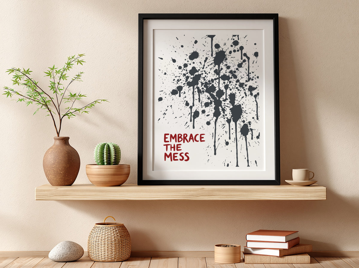 Motivational poster featuring Embrace The Mess text with abstract black ink splatter design