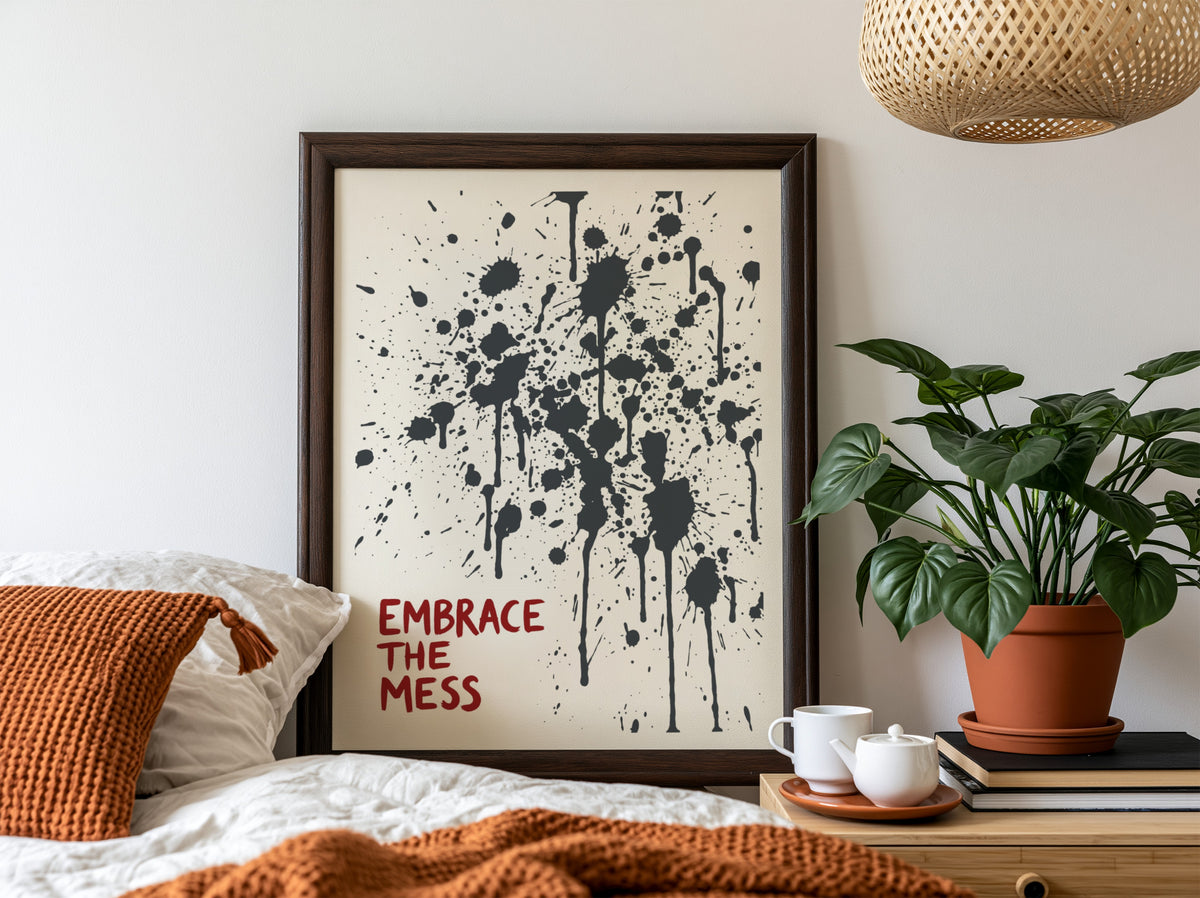 Motivational poster featuring Embrace The Mess text with abstract black ink splatter design