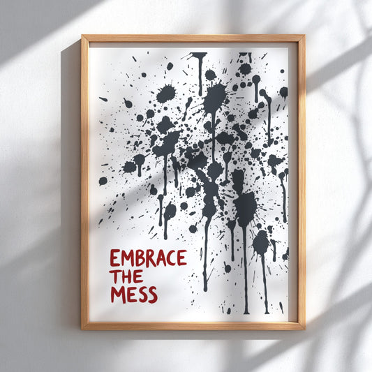 Motivational poster featuring Embrace The Mess text with abstract black ink splatter design