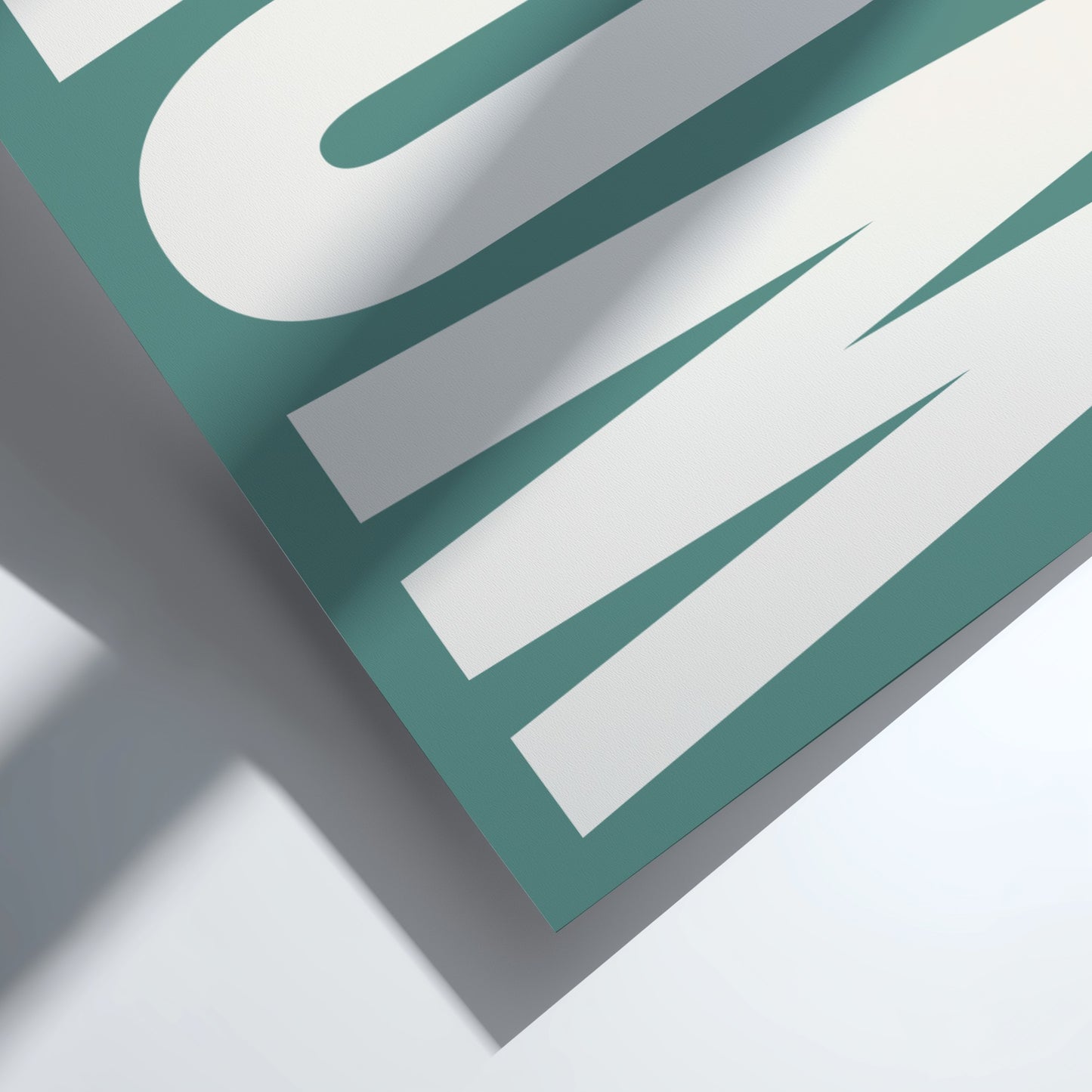 Close-up of a green and white sign with text on a light gray background