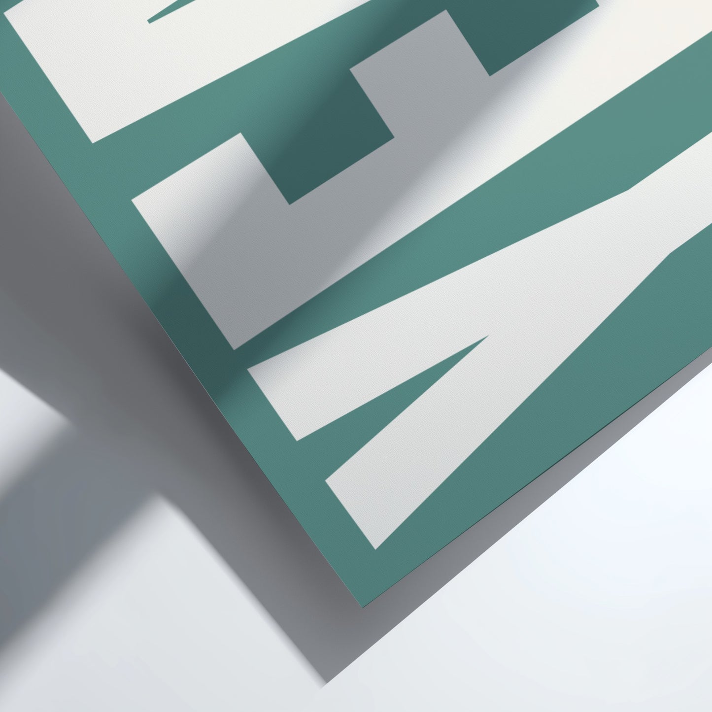 Close-up of a geometric design with green and white lines on a light gray background