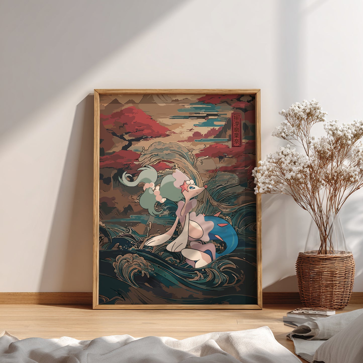 Framed artwork of a stylized Primarina Pokemon on a wall with a vase of dried flowers below.