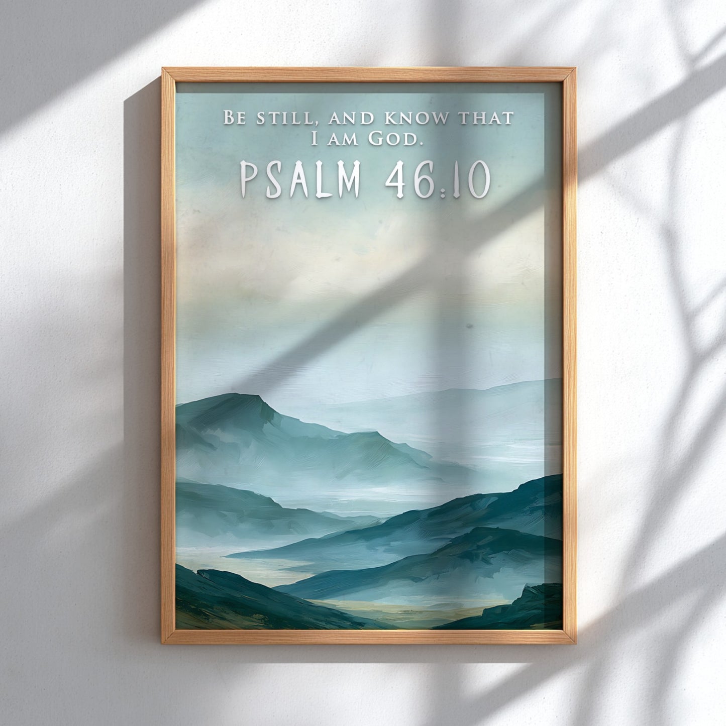 Poster featuring soft blue mountain ranges with the text Be Still And Know That I Am God.