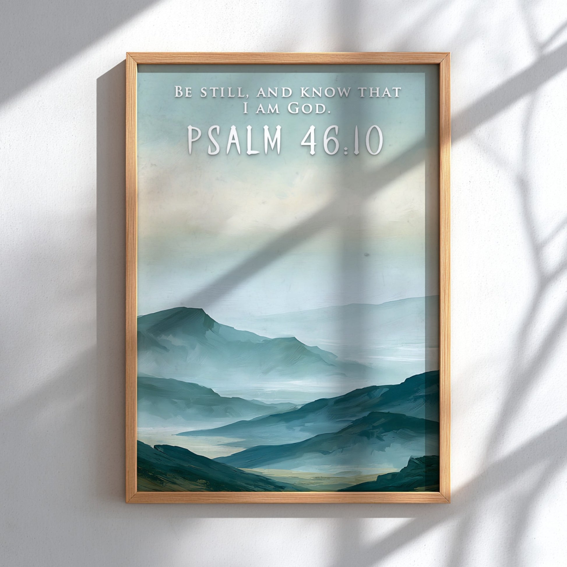 Poster featuring soft blue mountain ranges with the text Be Still And Know That I Am God.
