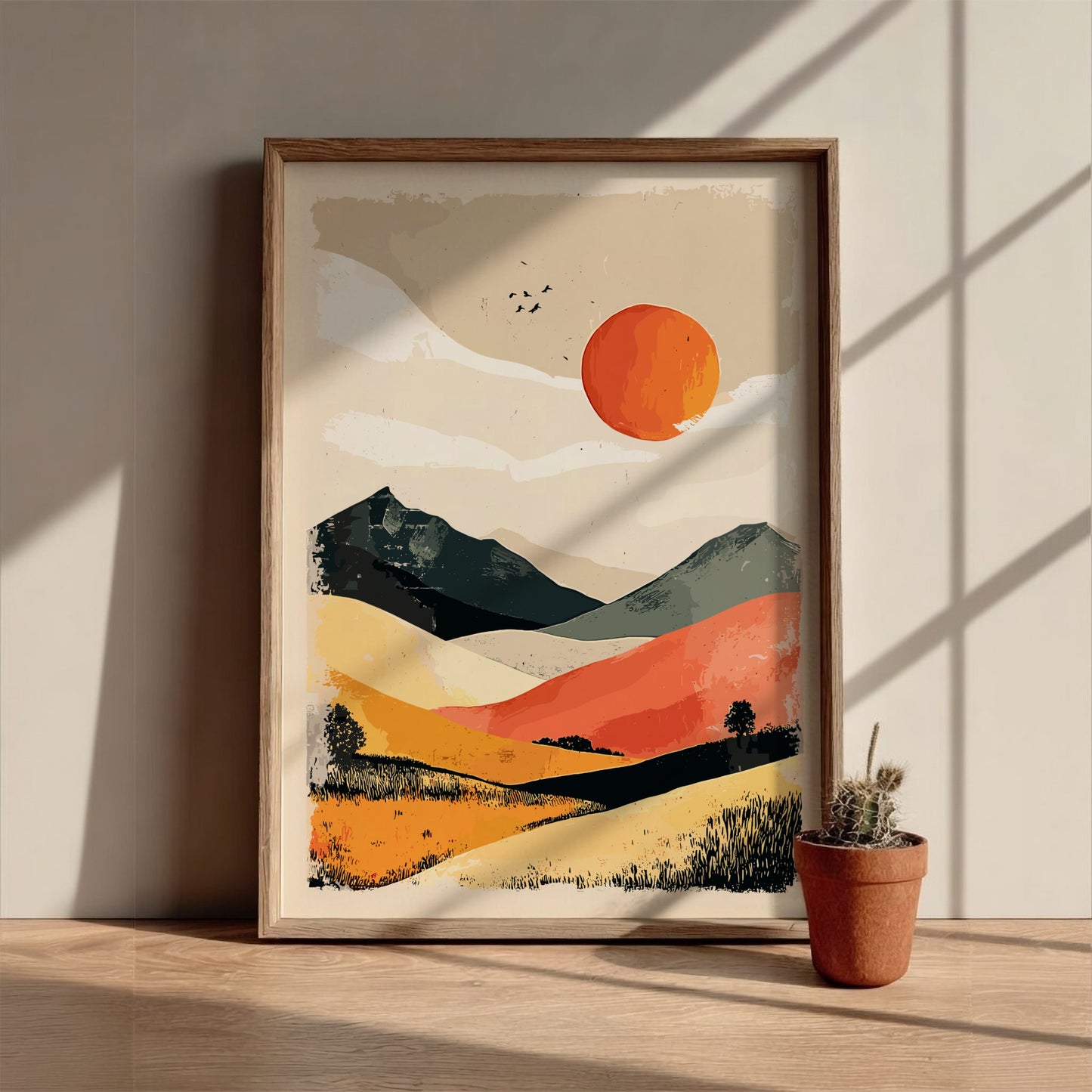 Framed abstract landscape painting on a wall with a potted plant below.
