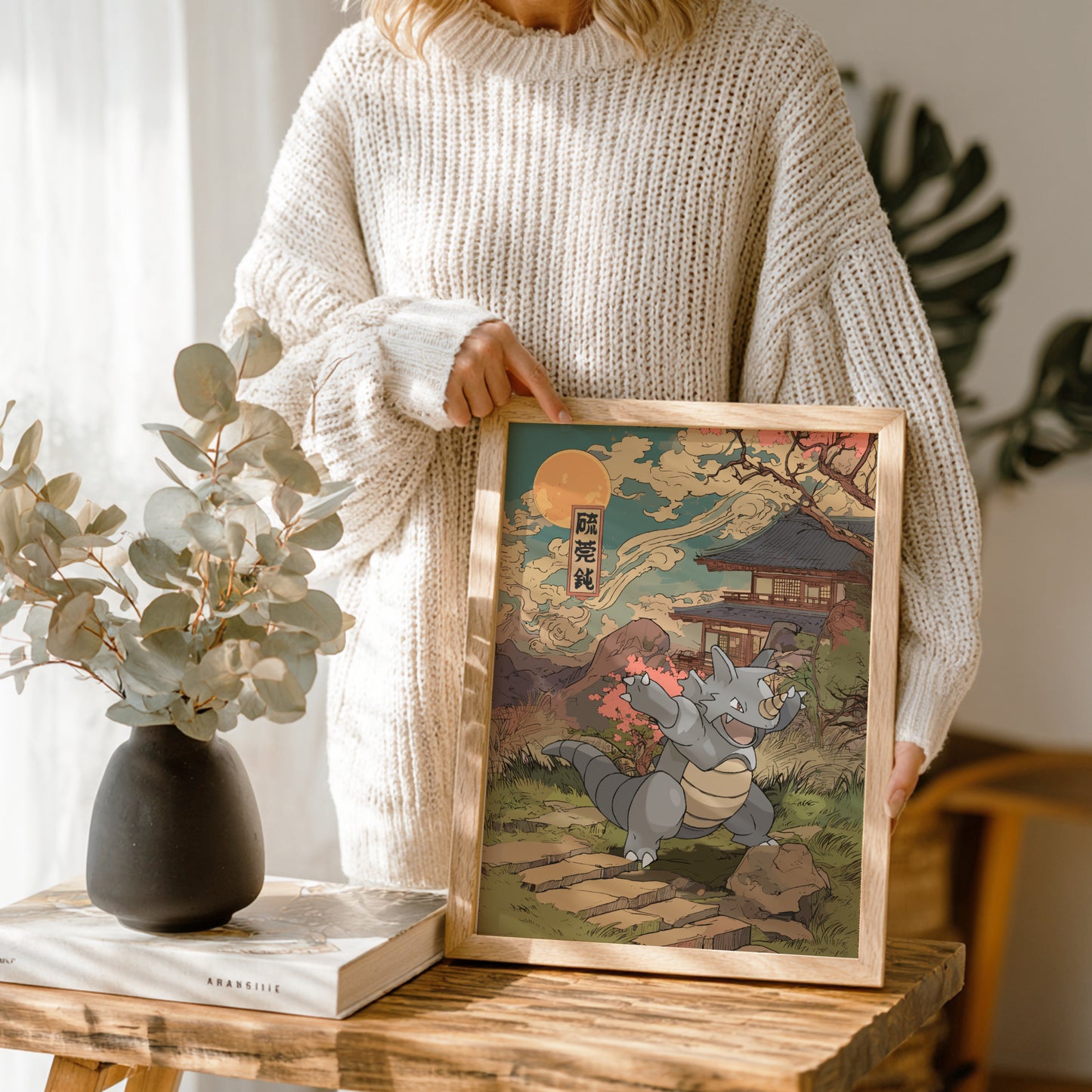 Person holding a framed artwork of Rhydon Pokemon in a traditional setting