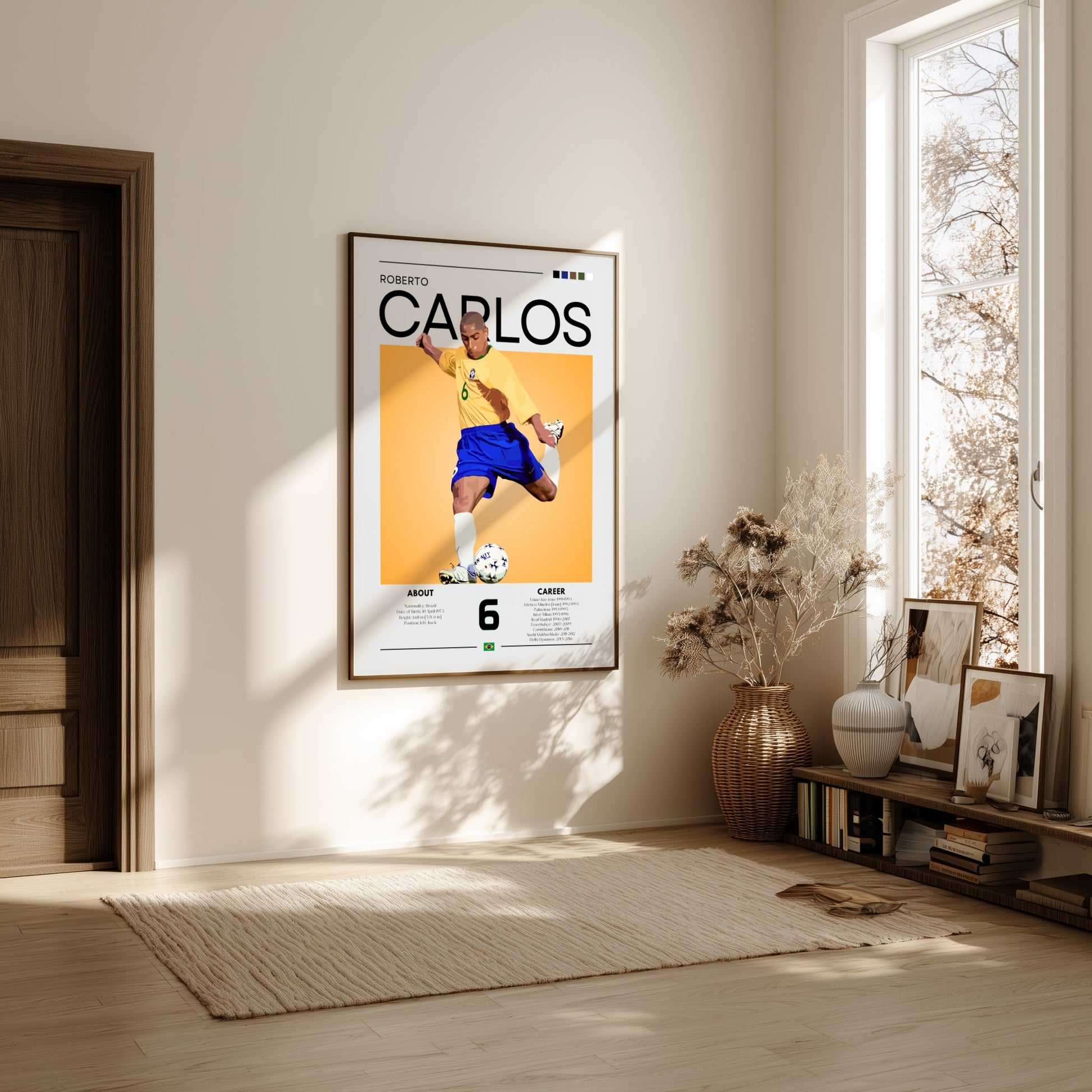 Framed poster of a soccer player named 'Carlos' in a room with natural light.