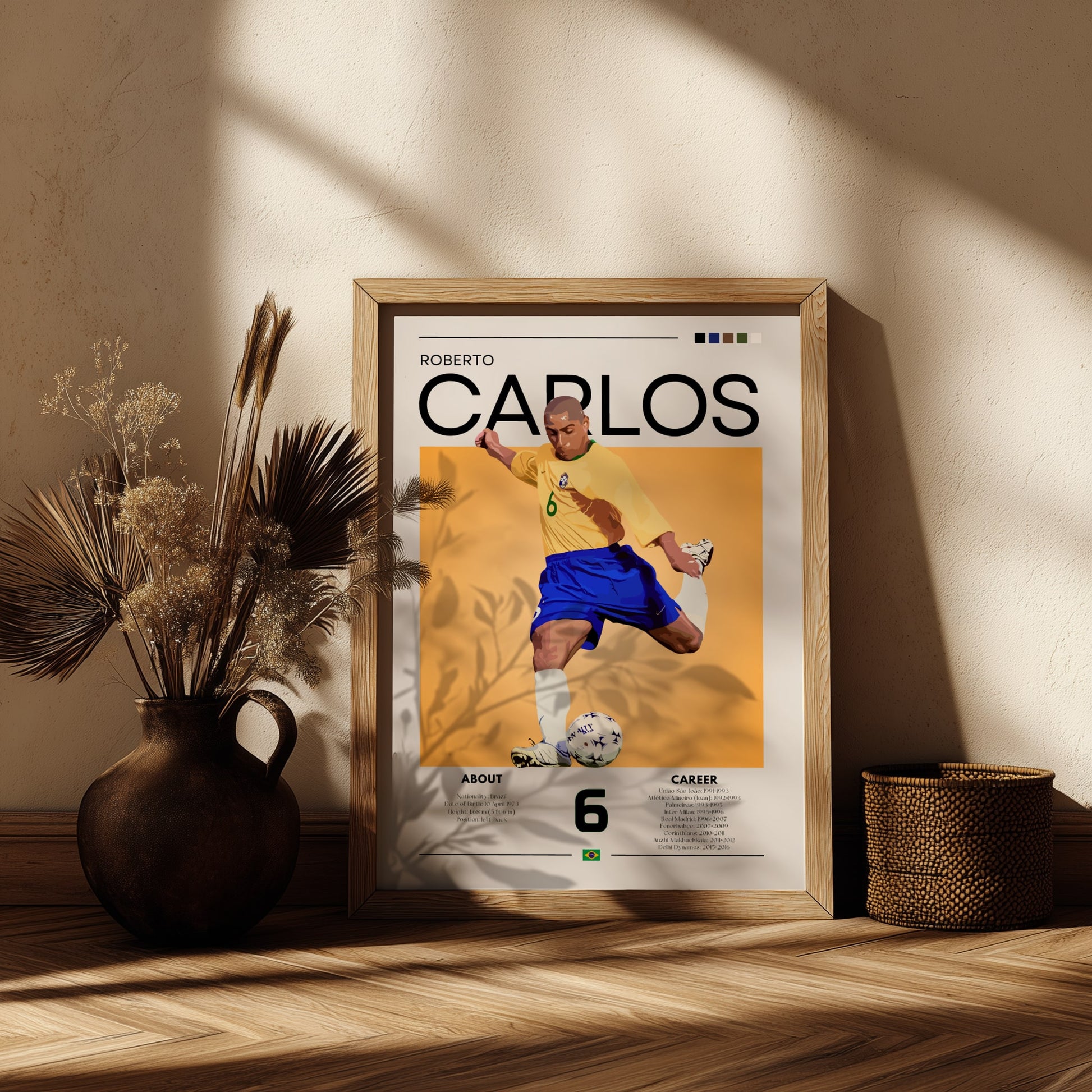 Framed poster of Roberto Carlos in a yellow jersey on a wooden shelf with decorative plants.
