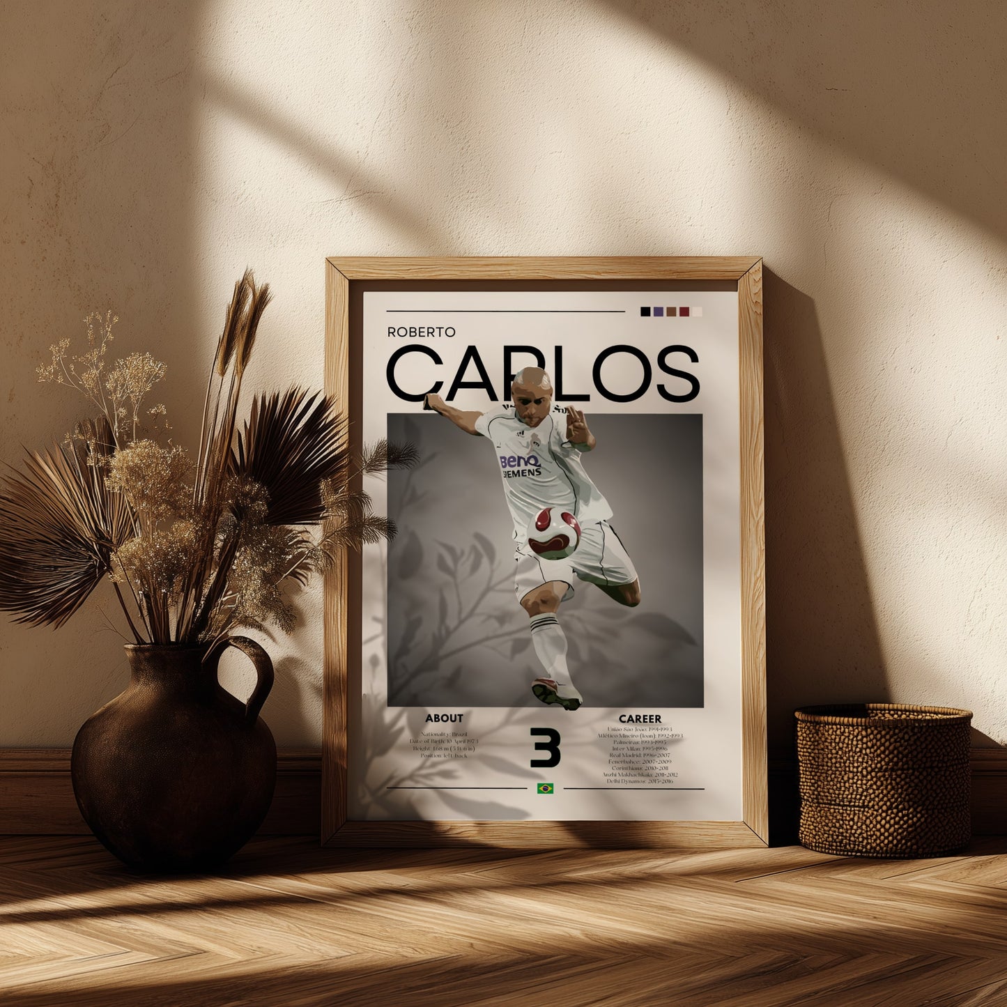 Framed poster of Roberto Carlos on a wooden shelf with decorative plants.