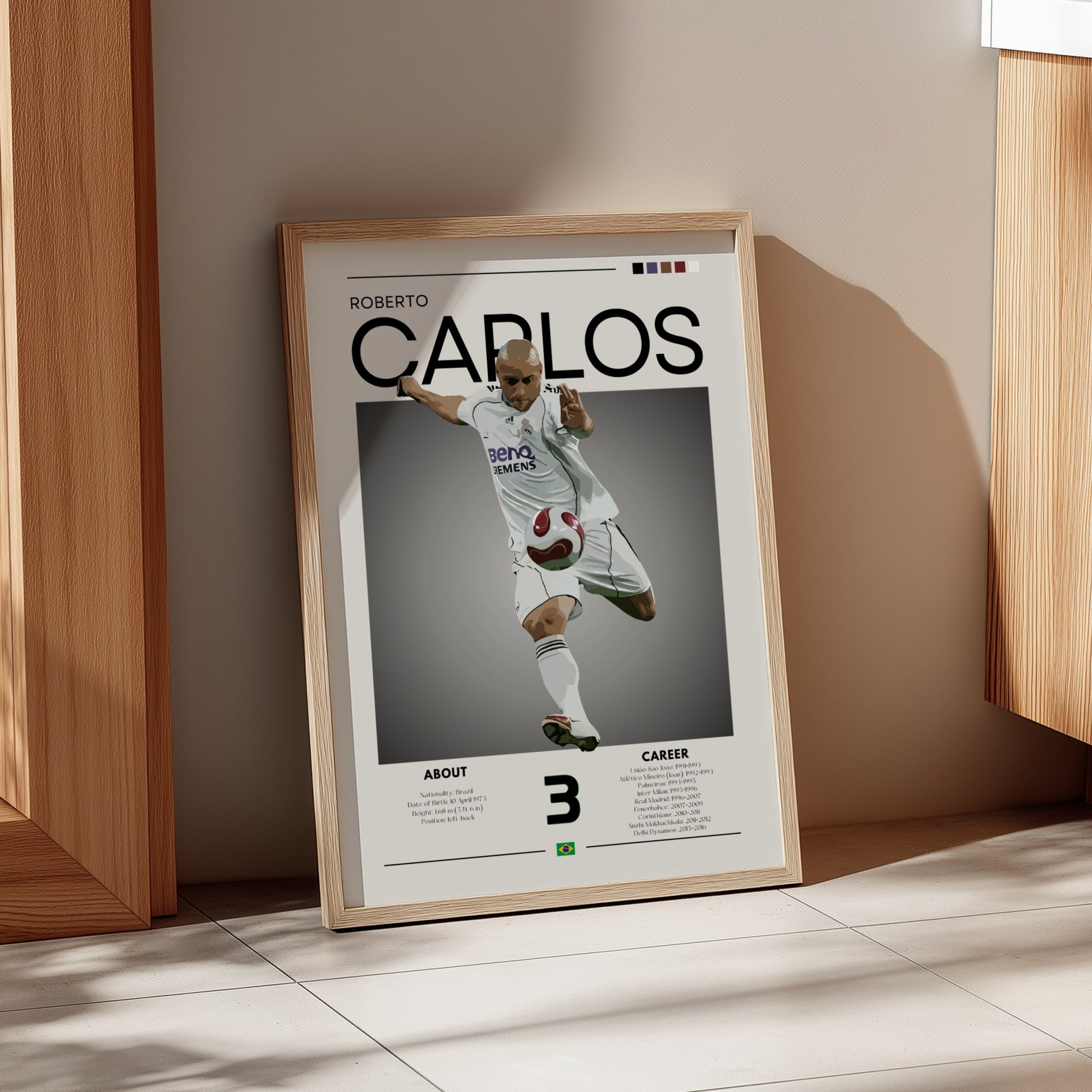 Framed poster of Roberto Carlos in a sports jersey on a wall.