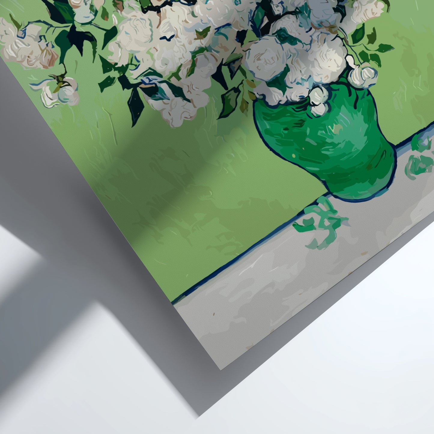 Vincent van Gogh's White Roses art poster in a green vase on a table.