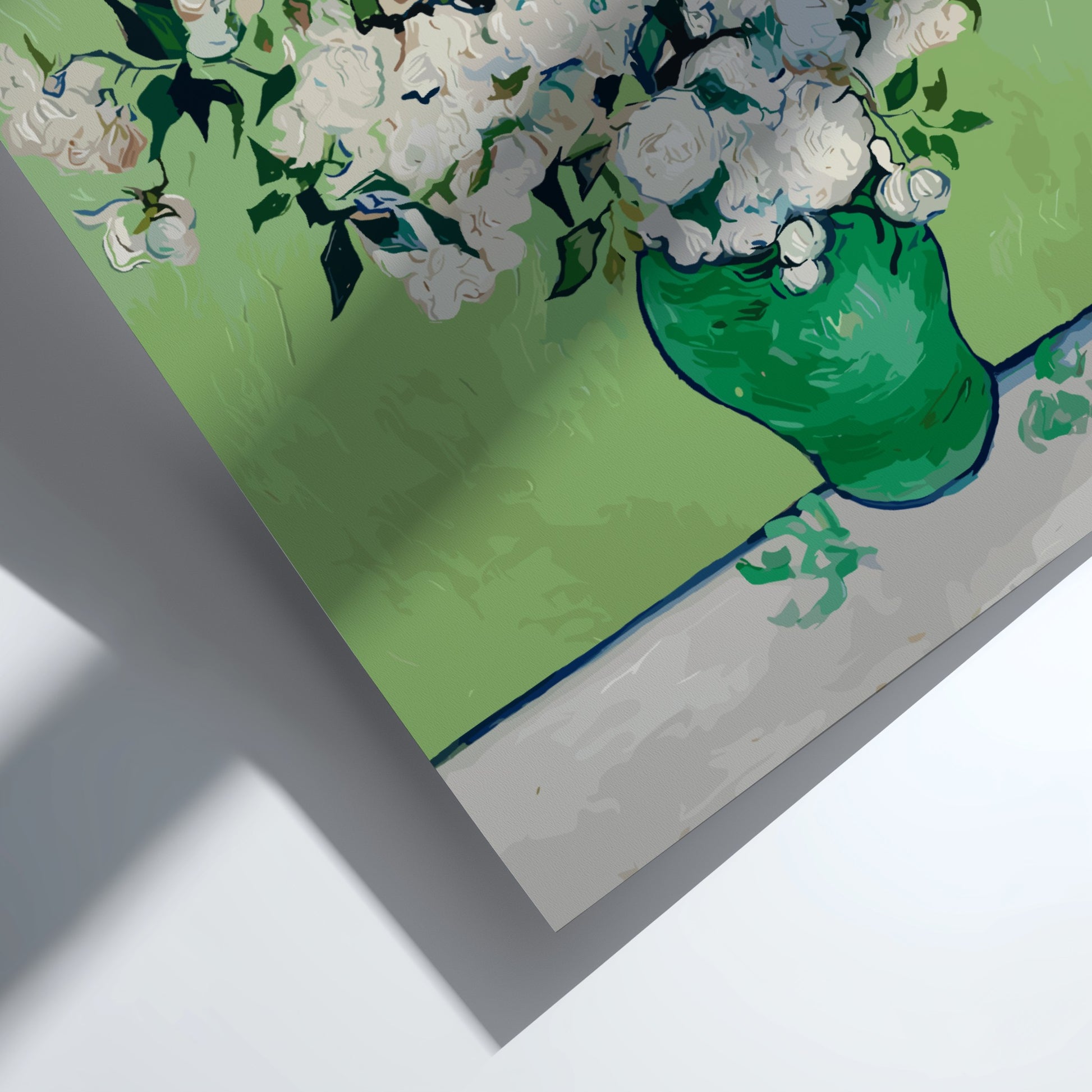 Vincent van Gogh's White Roses art poster in a green vase on a table.