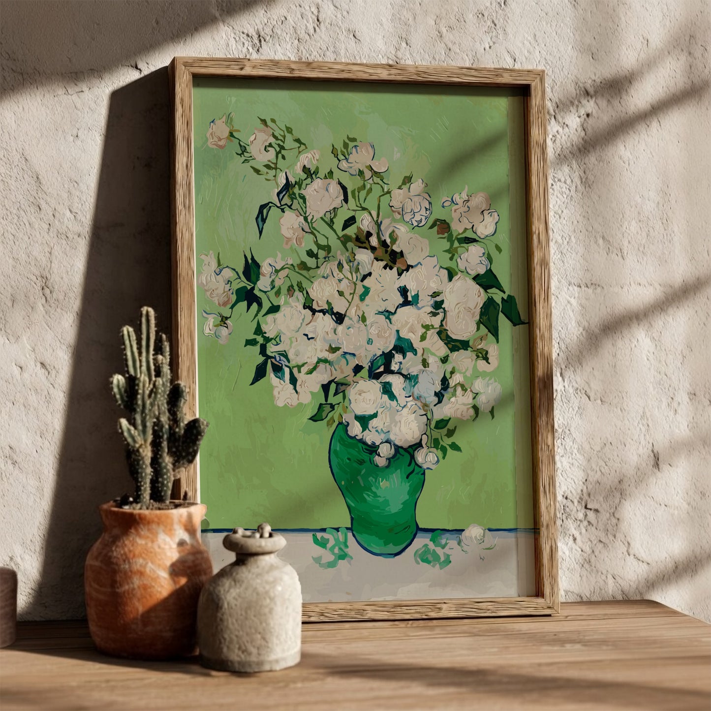Vincent van Gogh's White Roses art poster in a green vase on a table.