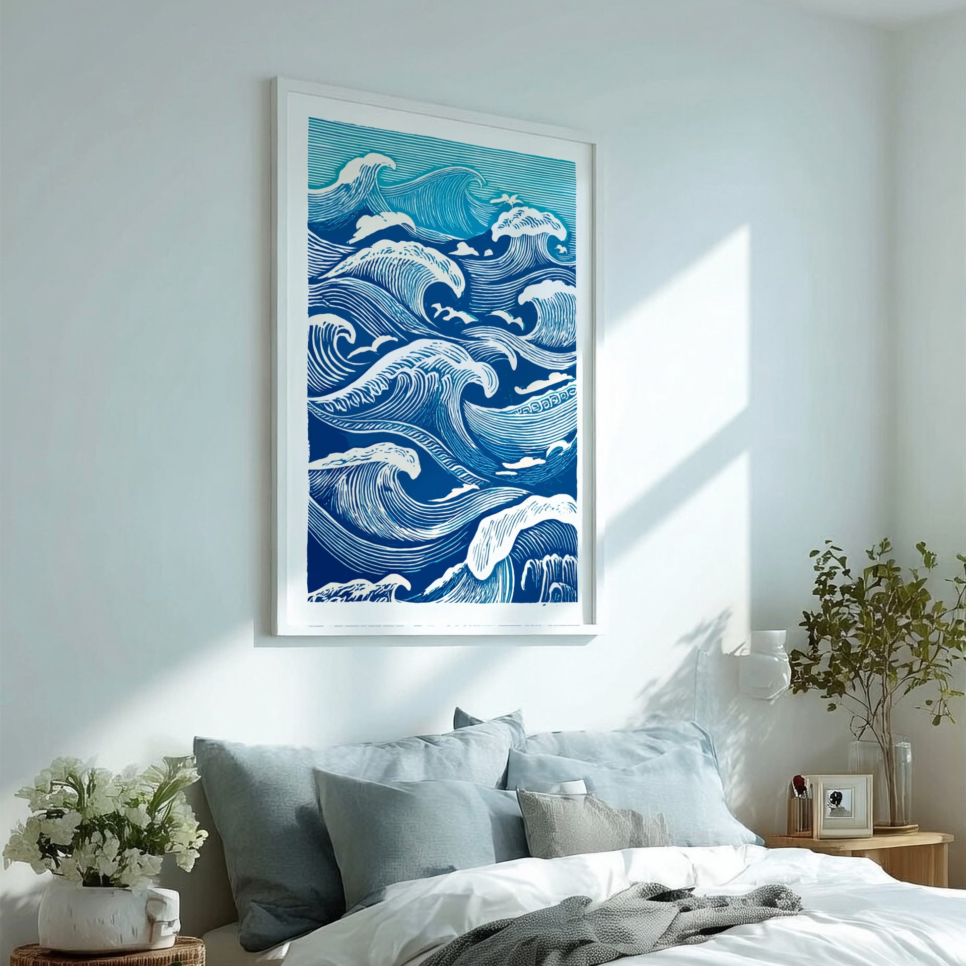 Framed artwork of blue waves on a wall above a bed with light blue bedding.