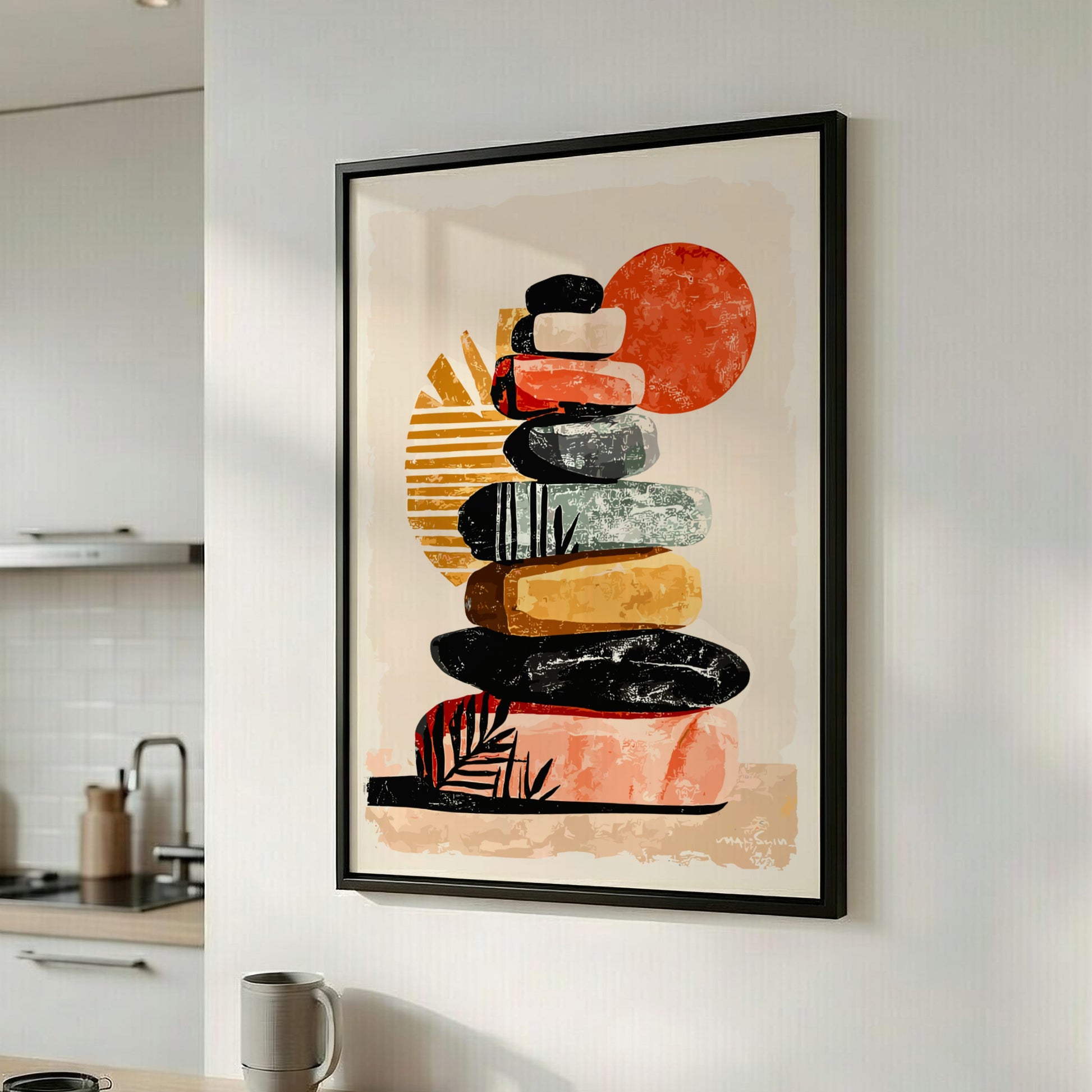 Framed abstract art print of stacked stones in a modern kitchen.