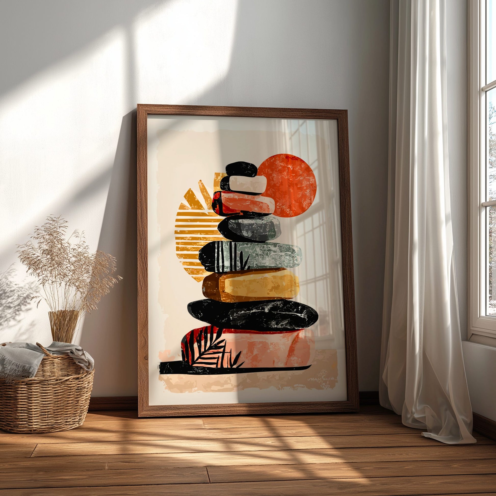 Framed abstract art print of stacked stones in a sunburst pattern on a wall.
