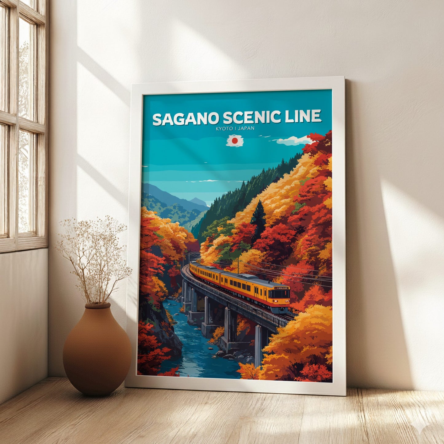 Framed poster of Sagano Scenic Line with a train and autumn foliage in a room with a window.