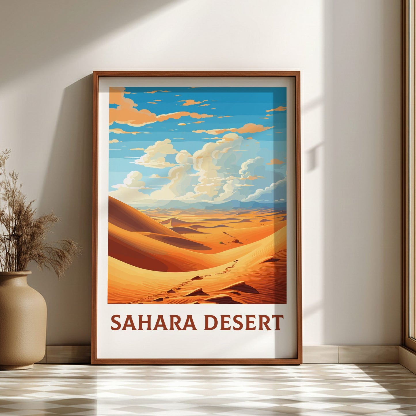 Framed poster of Sahara Desert landscape on a wall.