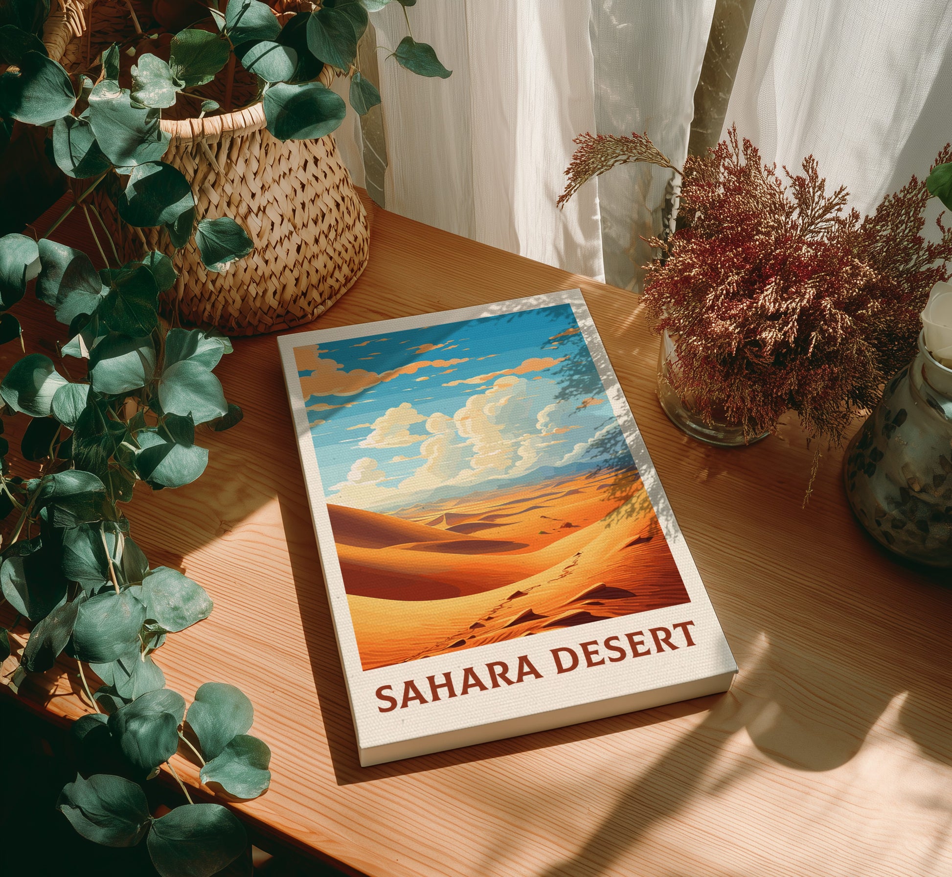 Canvas 'Sahara Desert' on a wooden table with decorative plants.